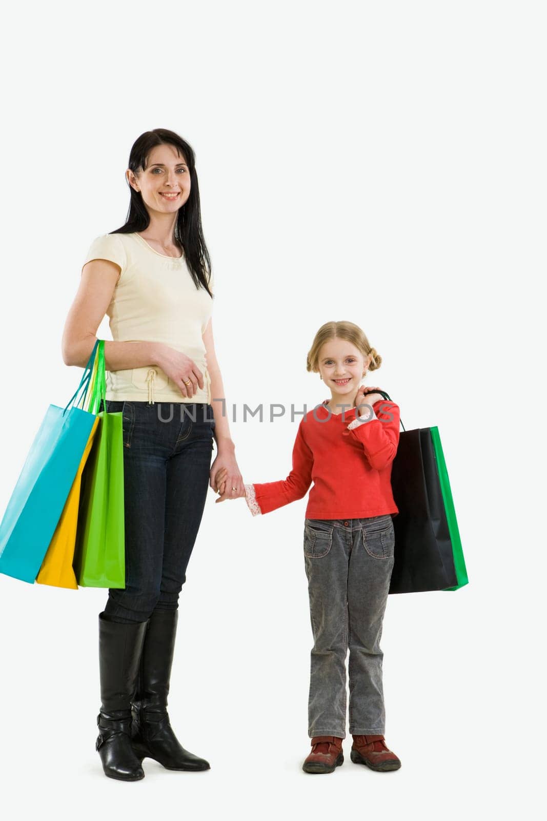 Portrait of mother and daughter with paperbags after shopping