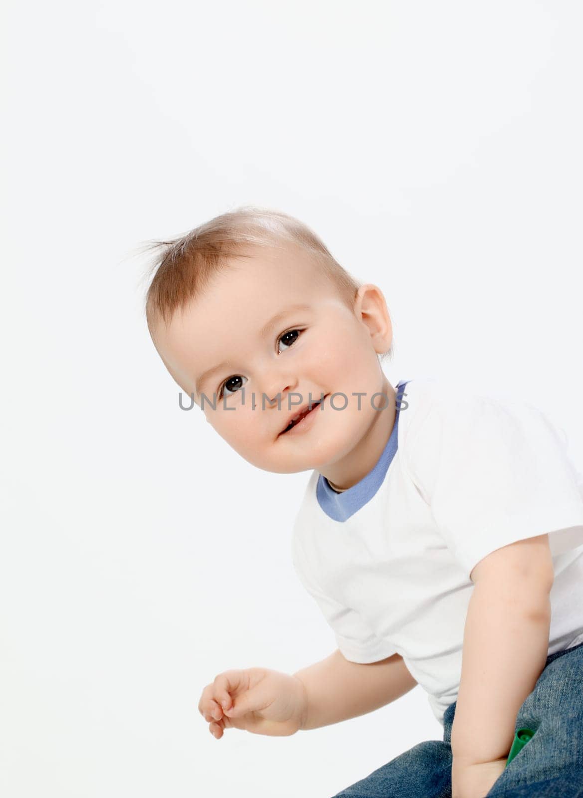 Portrait of happy boy laughing on white background