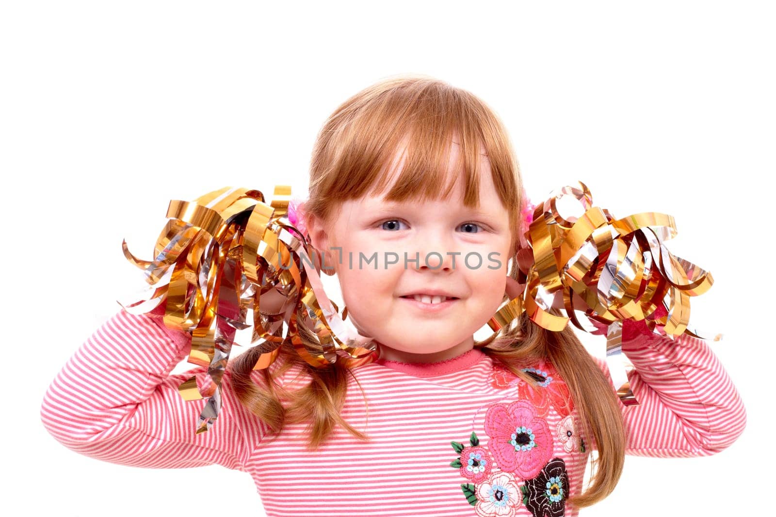 Portrait of happy girl with decorative ribbons looking at camera
