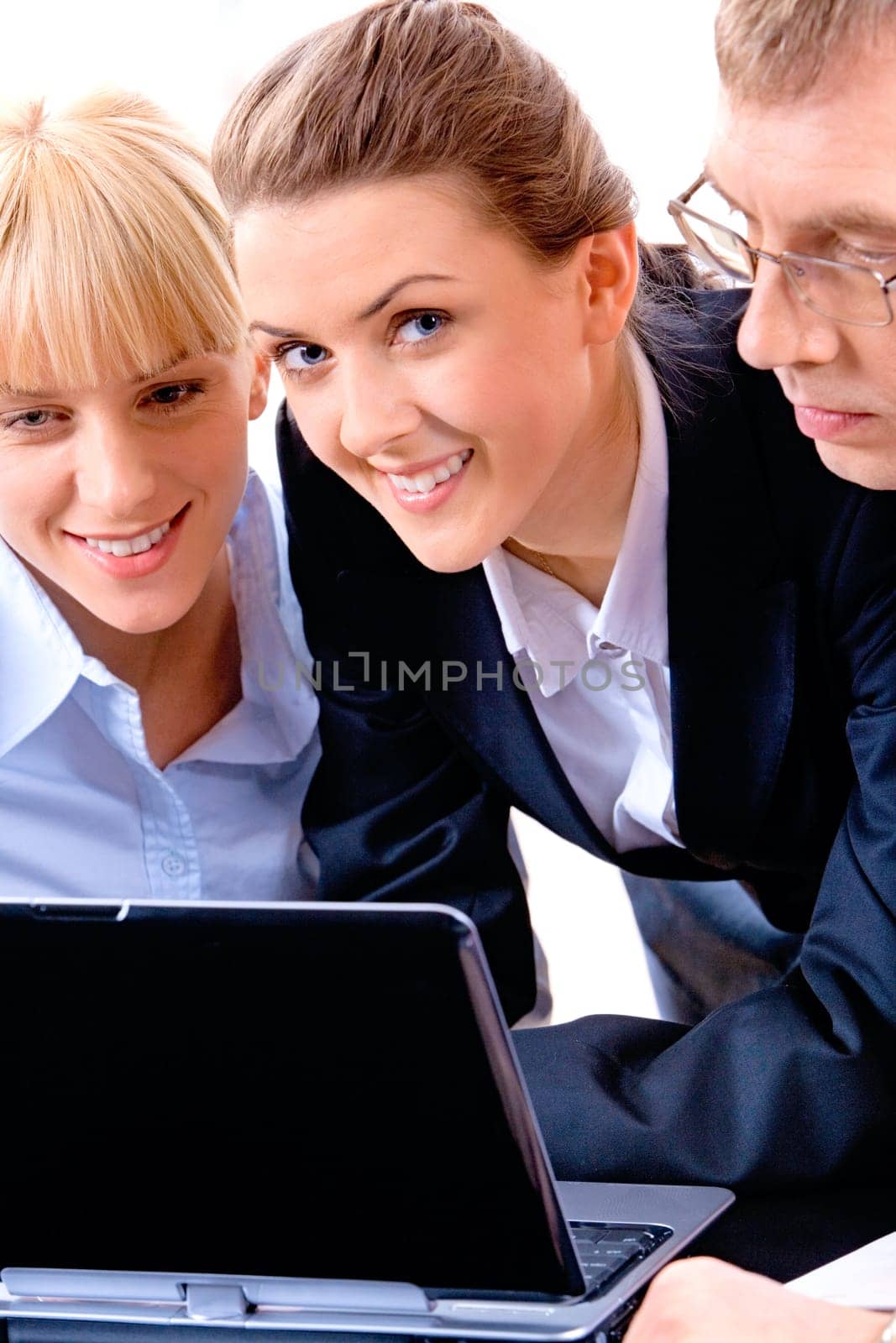 Image of three business people with a brunette young woman at the front