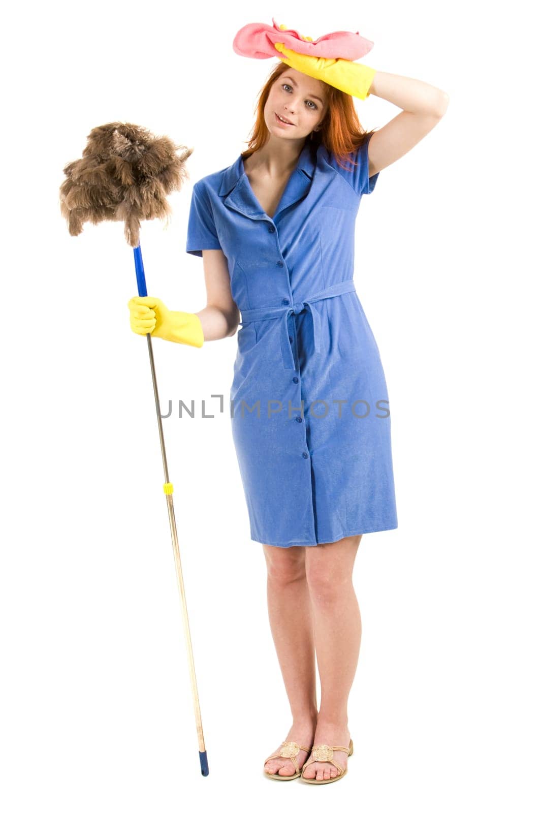 Portrait of nice housewife wearing blue robe with brush and duster in hands