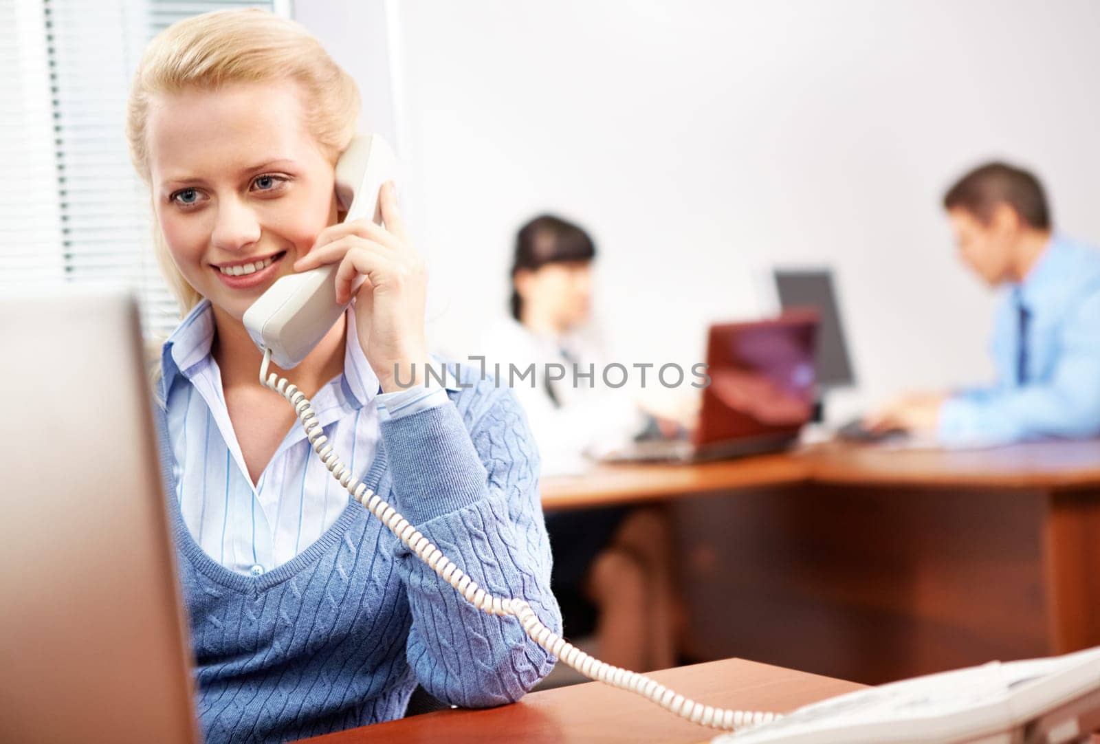 A young woman secretary talking on the phone