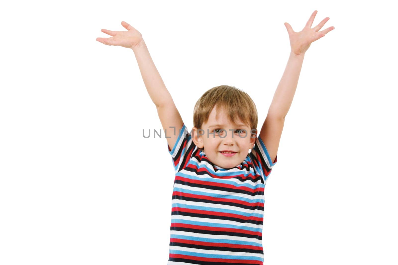 Portrait of joyful boy looking at camera with raised arms