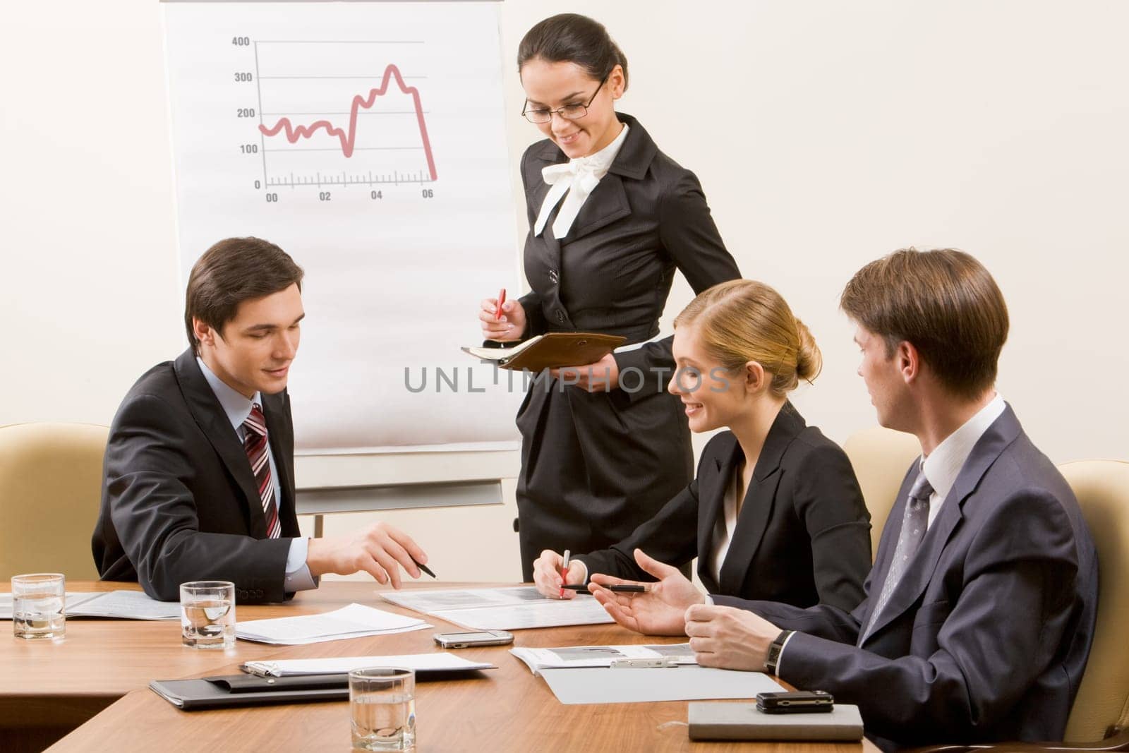 Image of business team looking at document and discussing it in office