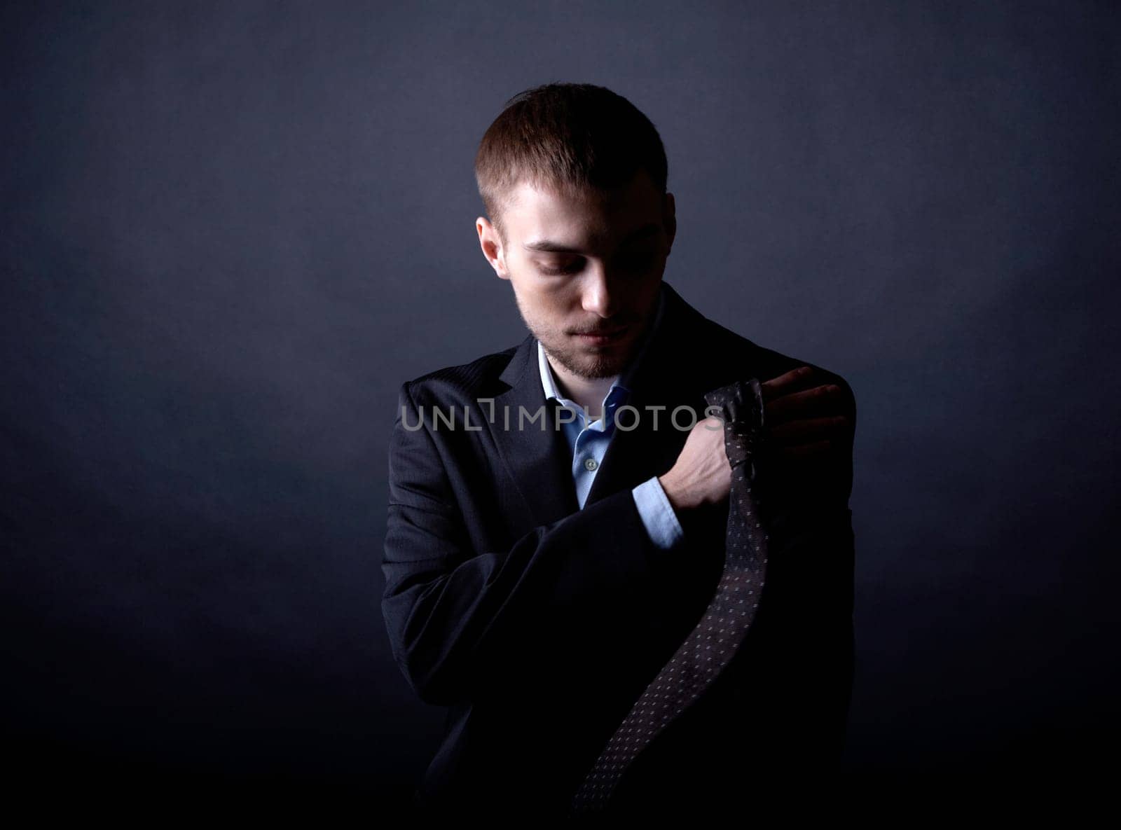 Portrait of serious businessman in darkness