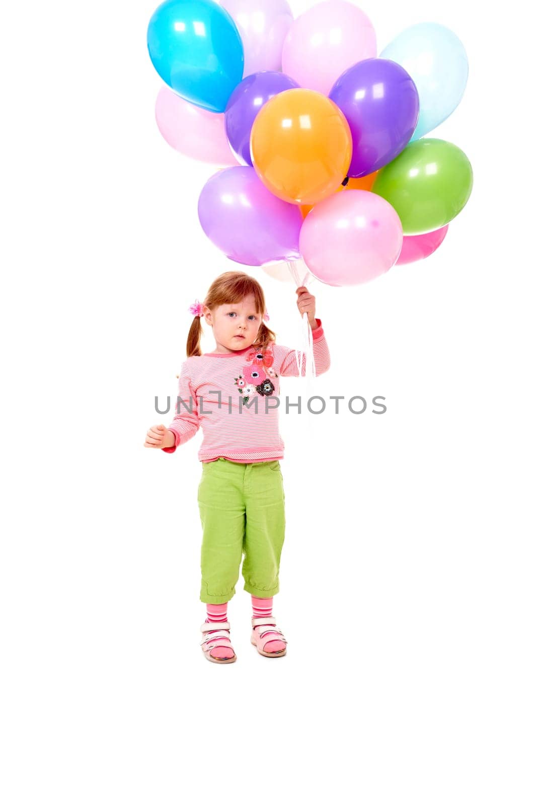 Image of small girl with helium balloons at party