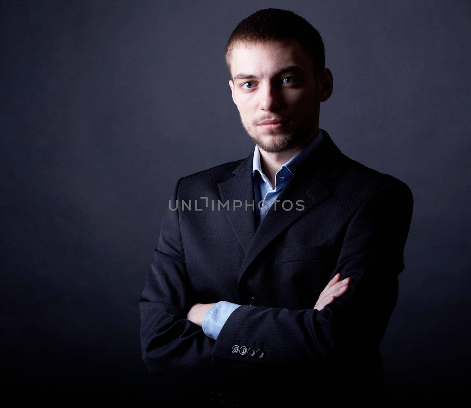 Portrait of serious businessman in darkness