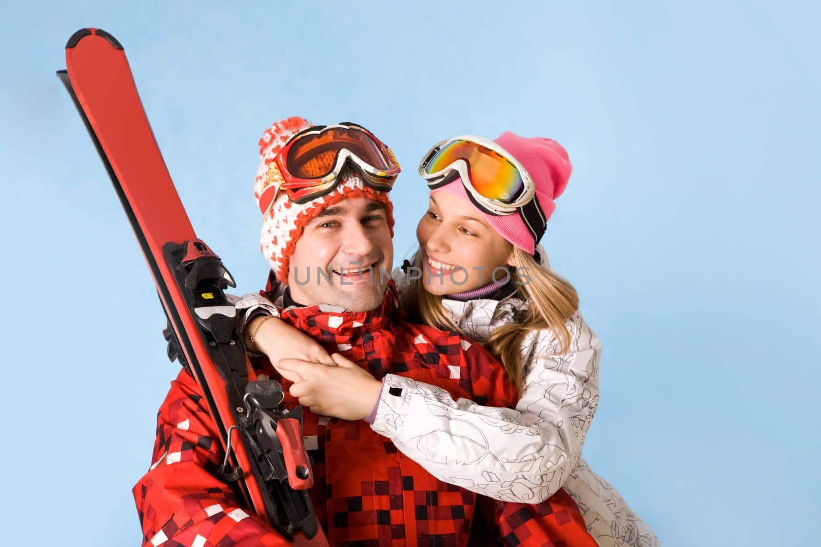 Portrait of happy female looking at sporty man while embracing him