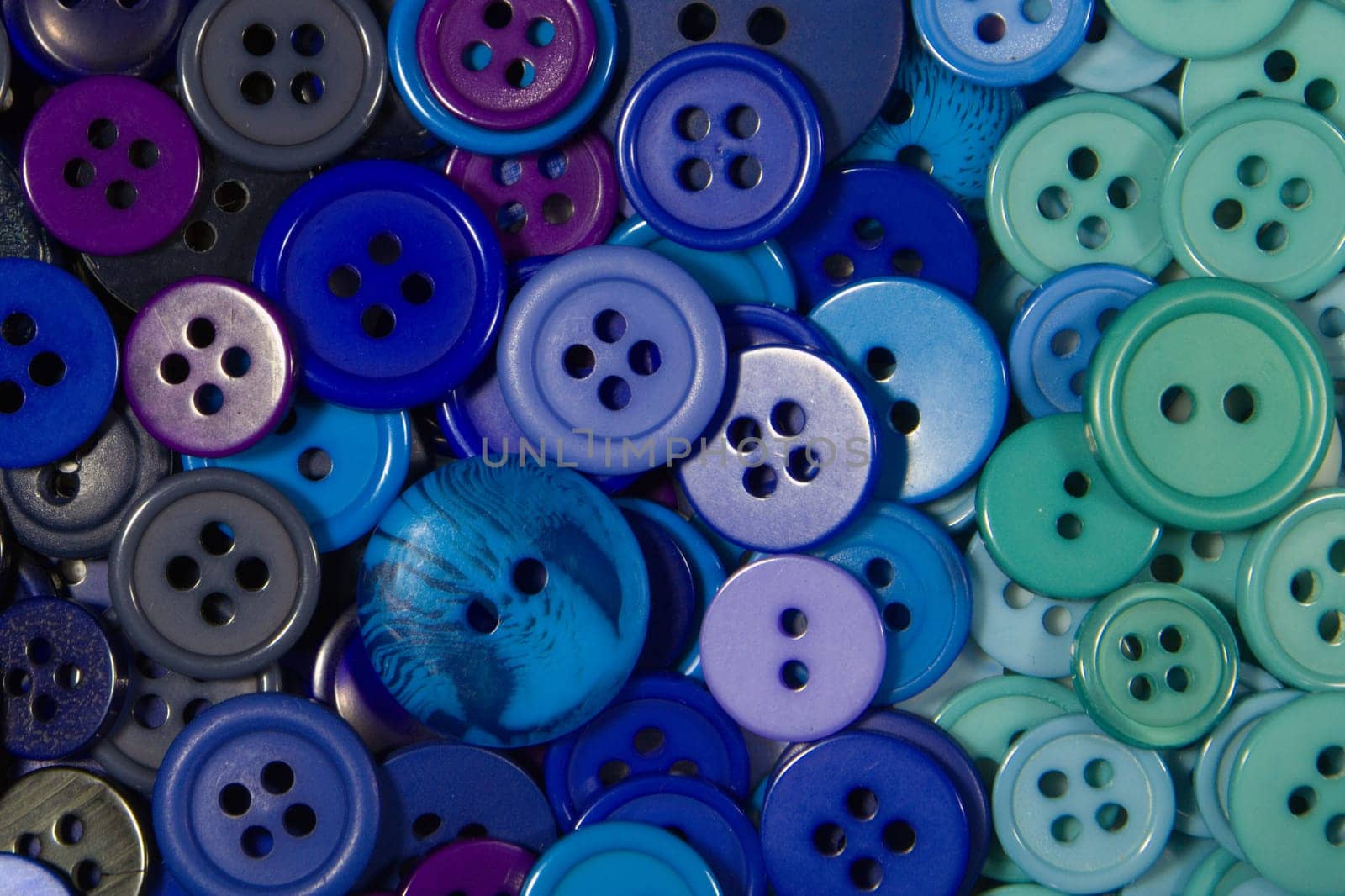 Blue buttons, small and large as a background texture.