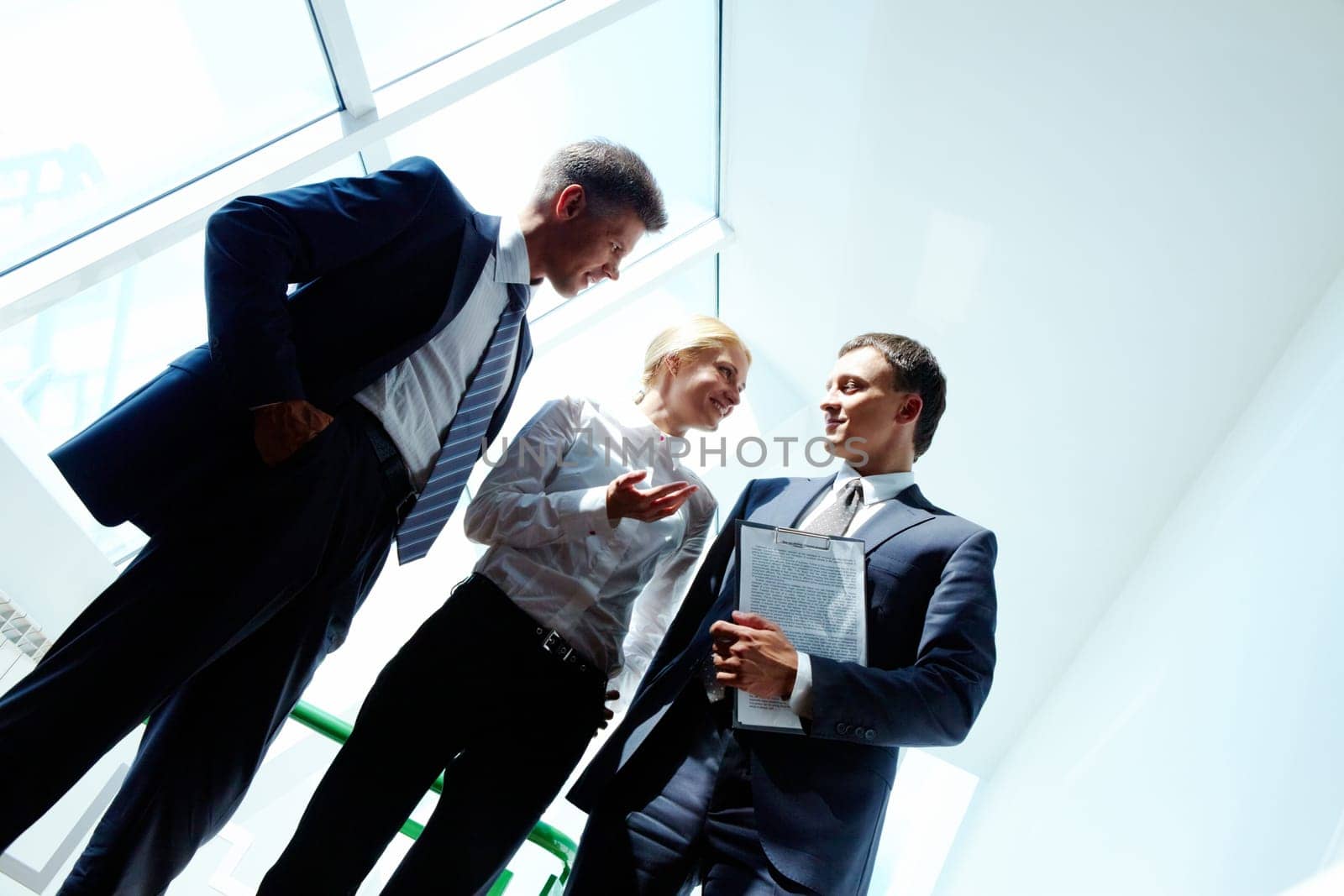 Three smart employees discussing new strategy at meeting