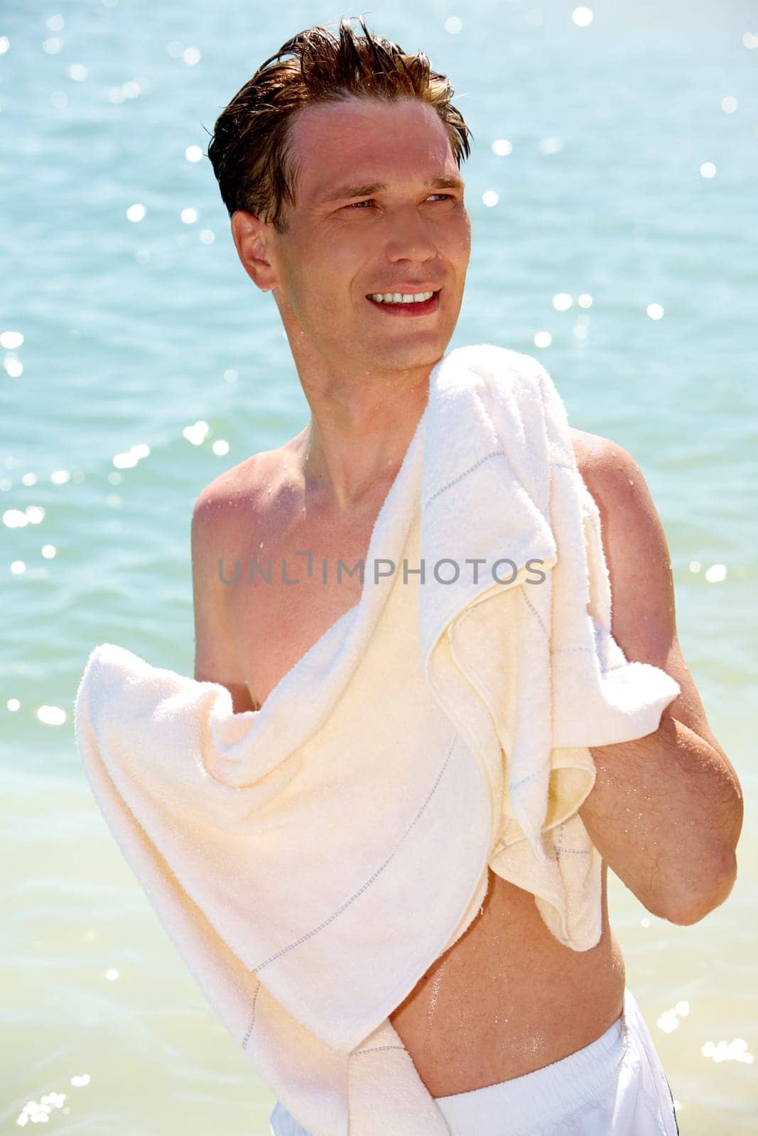 Photo of man wiping his body after swimming