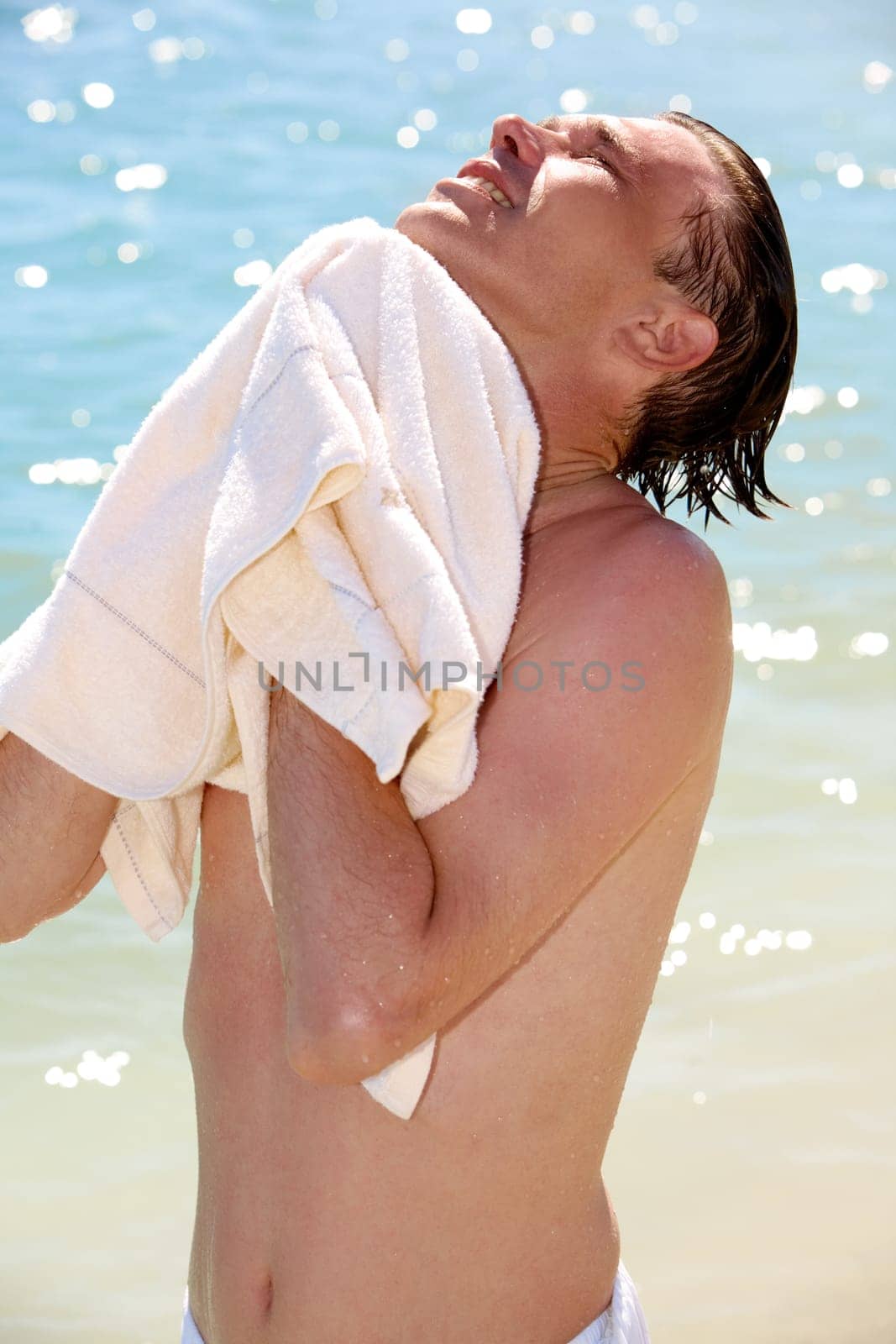 Photo of man wiping his body after swimming