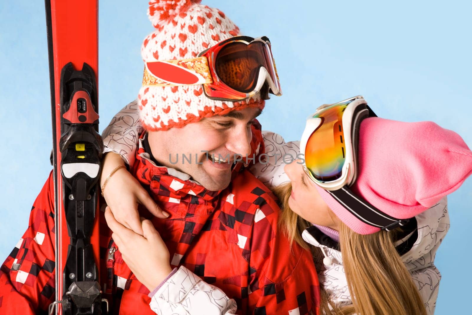 Portrait of happy female looking at sporty man while embracing him