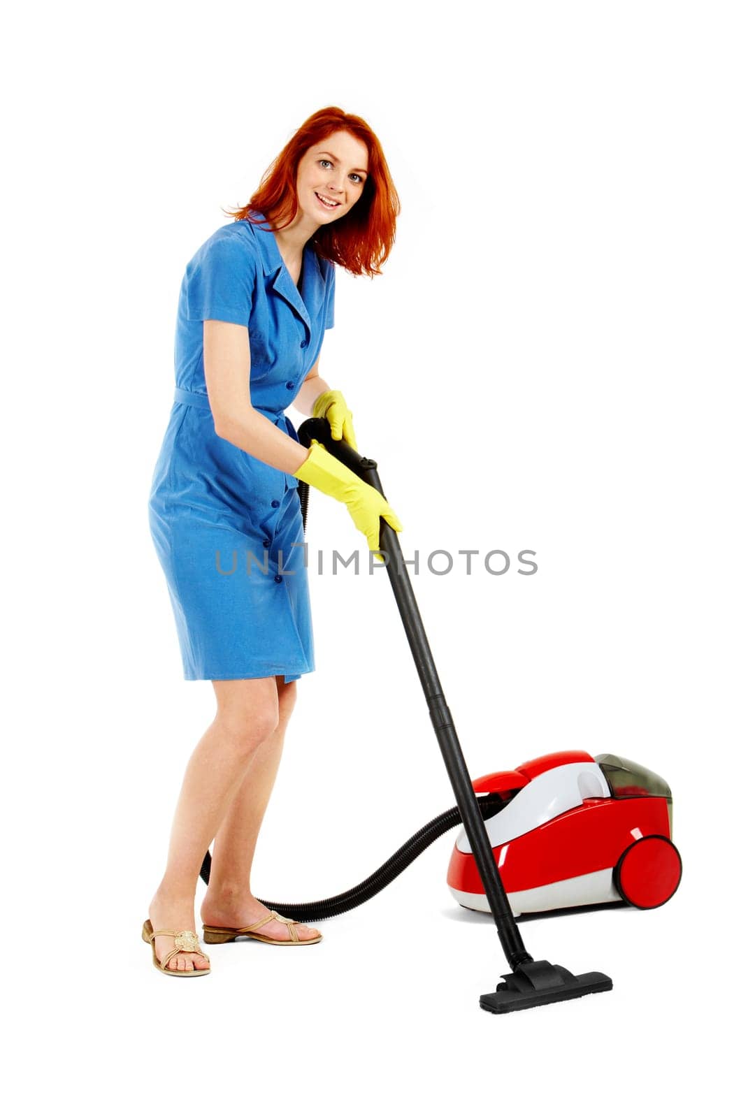 Portrait of nice housewife doing housework with vacuum cleaner