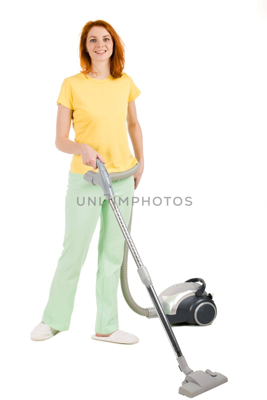 Portrait of nice housewife doing housework with vacuum cleaner