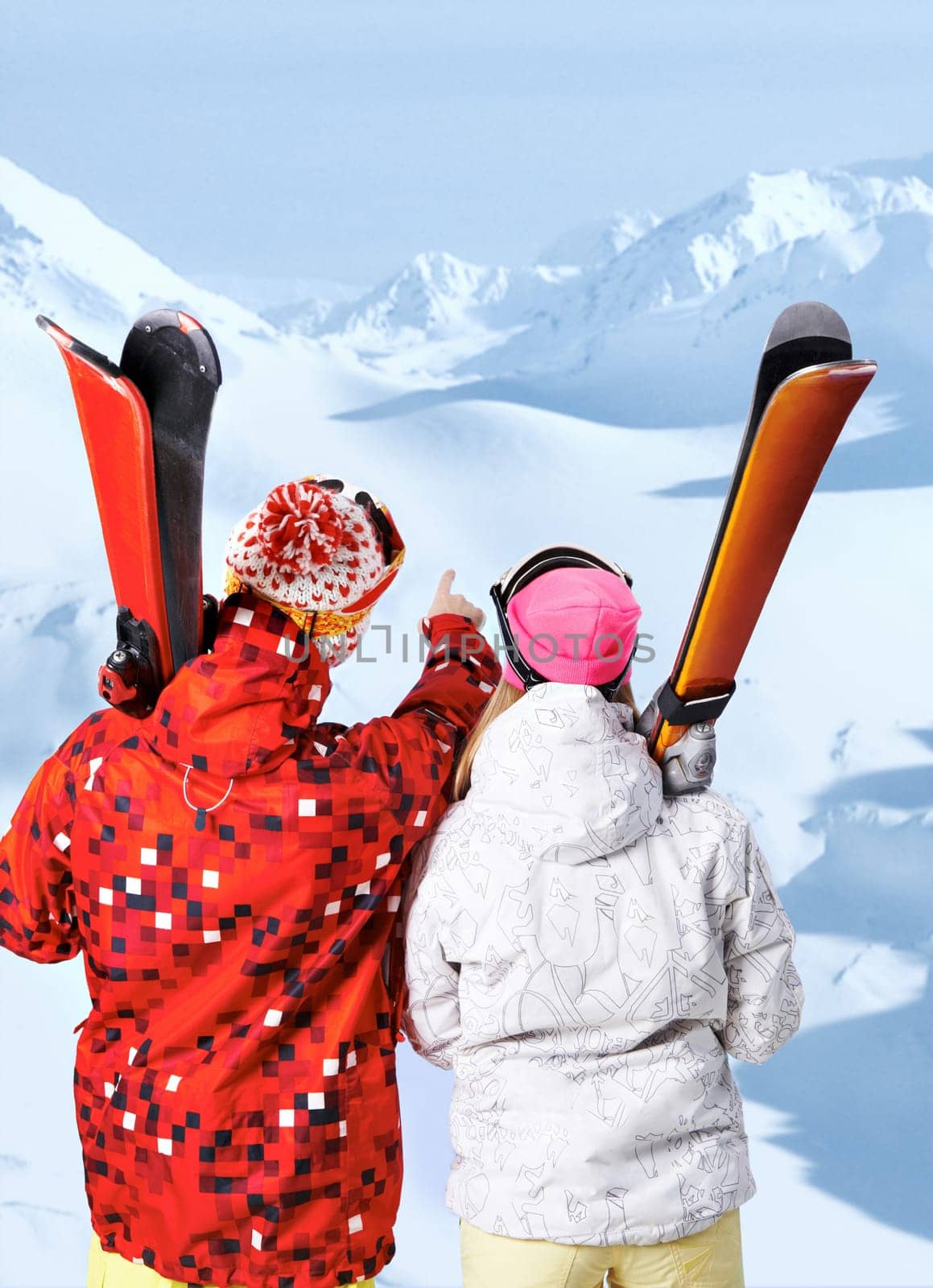 Back view of sporty couple with skis at winter resort