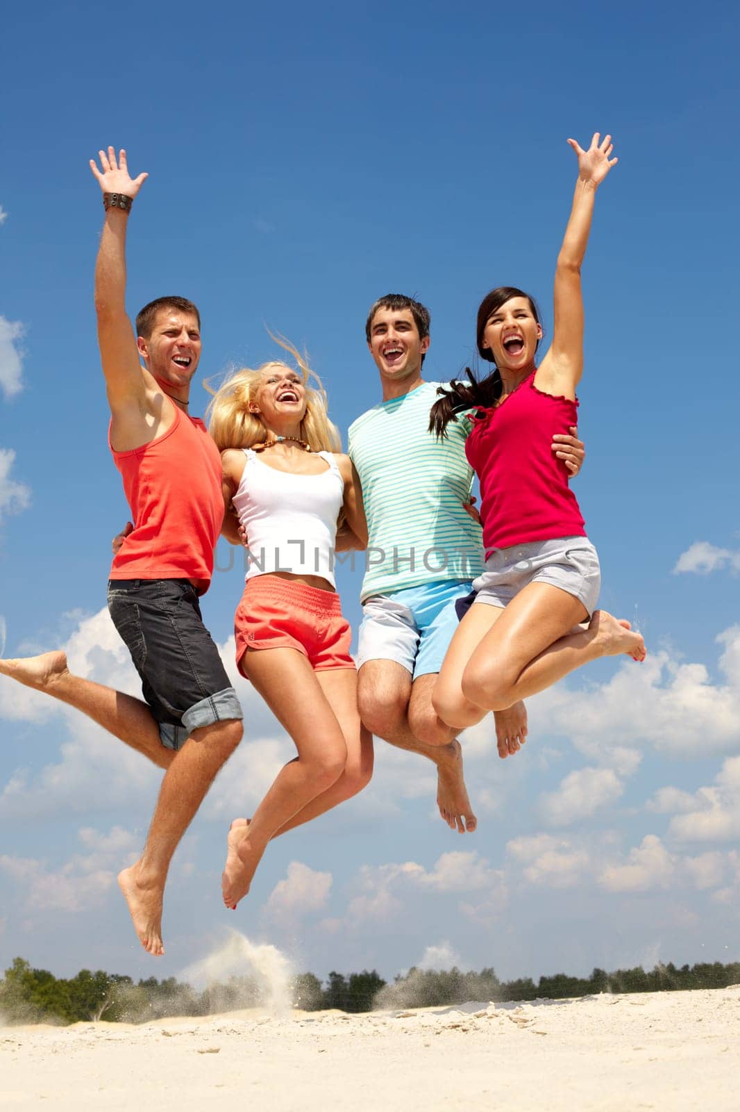 Portrait of four jumping happy people
