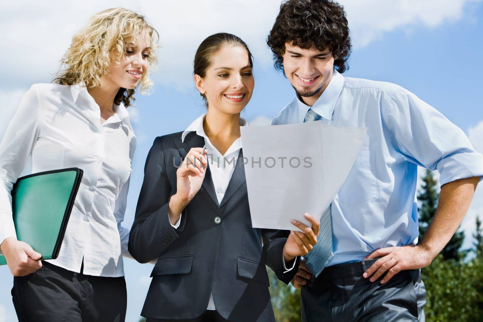 Businesspeople are discussing together a new contract on the street