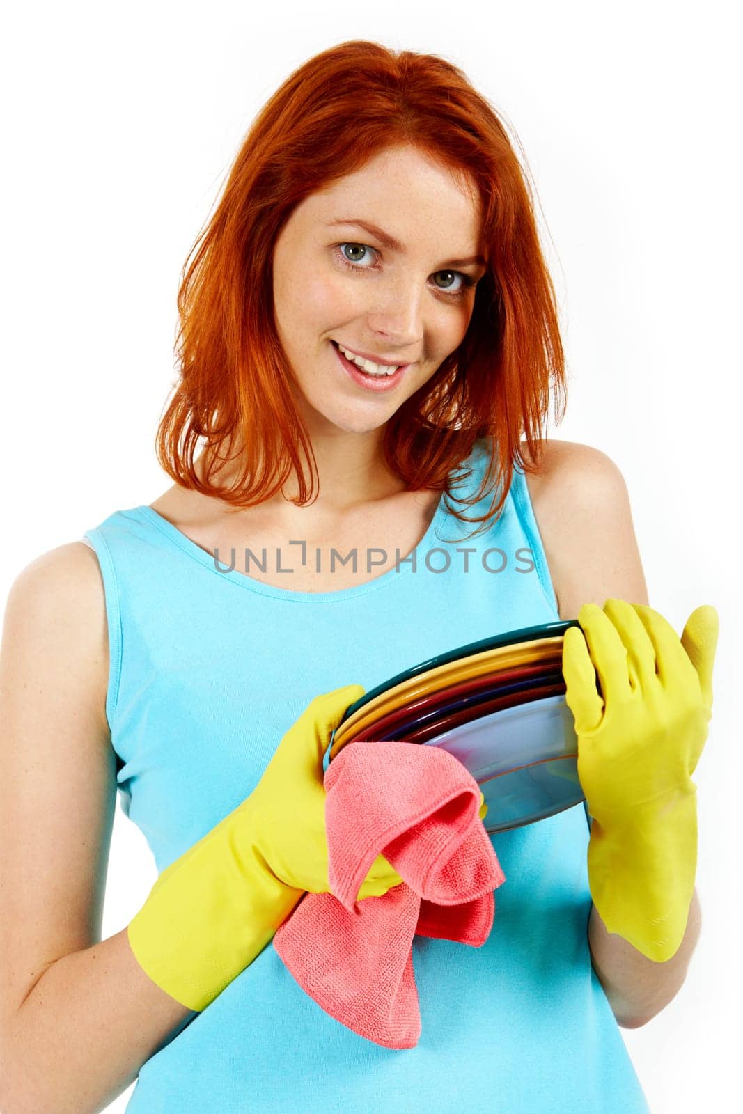 Portrait of young female holding plates and looking at camera