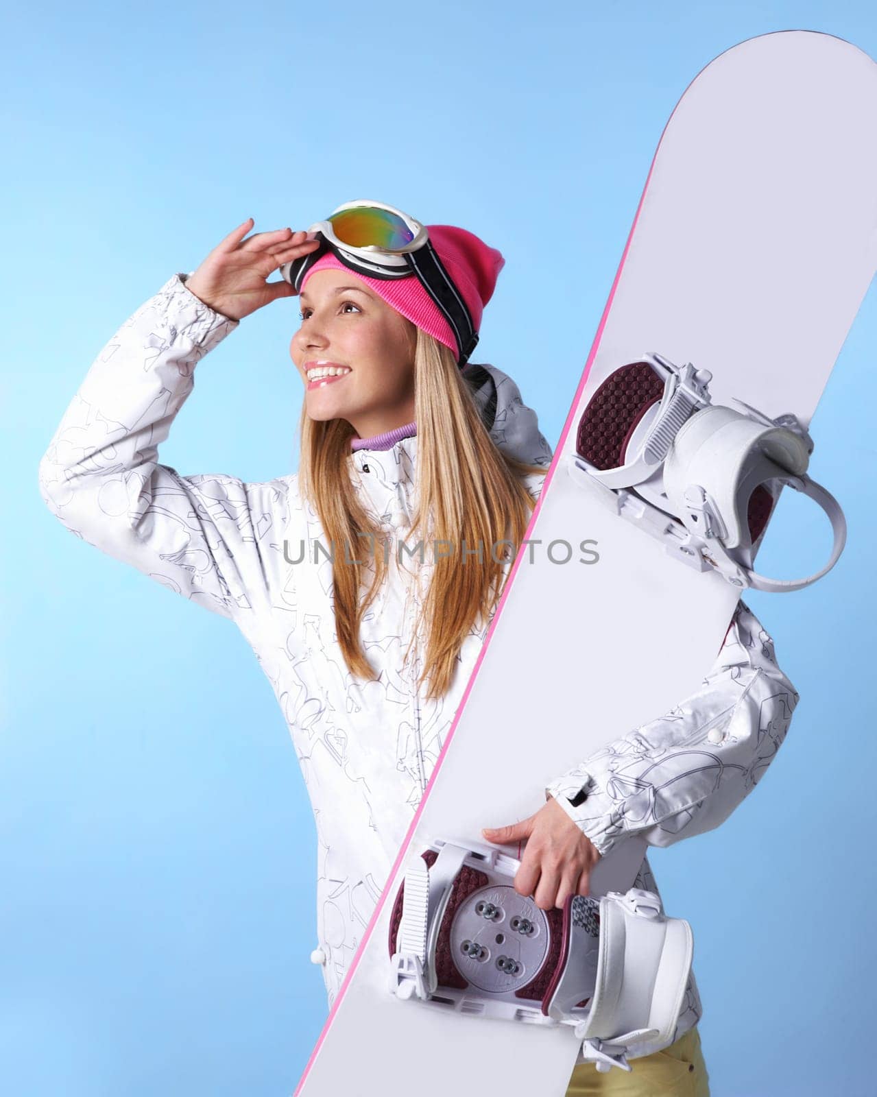 Portrait of healthy woman with pair of skis in hands looking somewhere