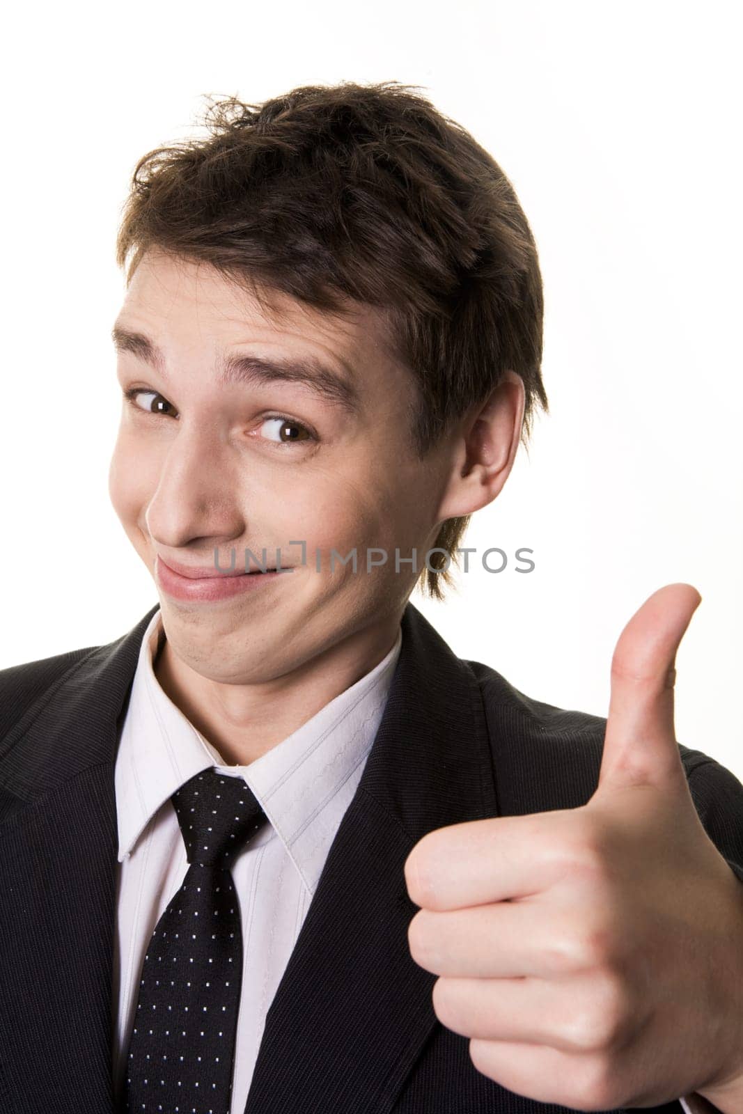 Portrait of successful male holding his thumb up and smiling