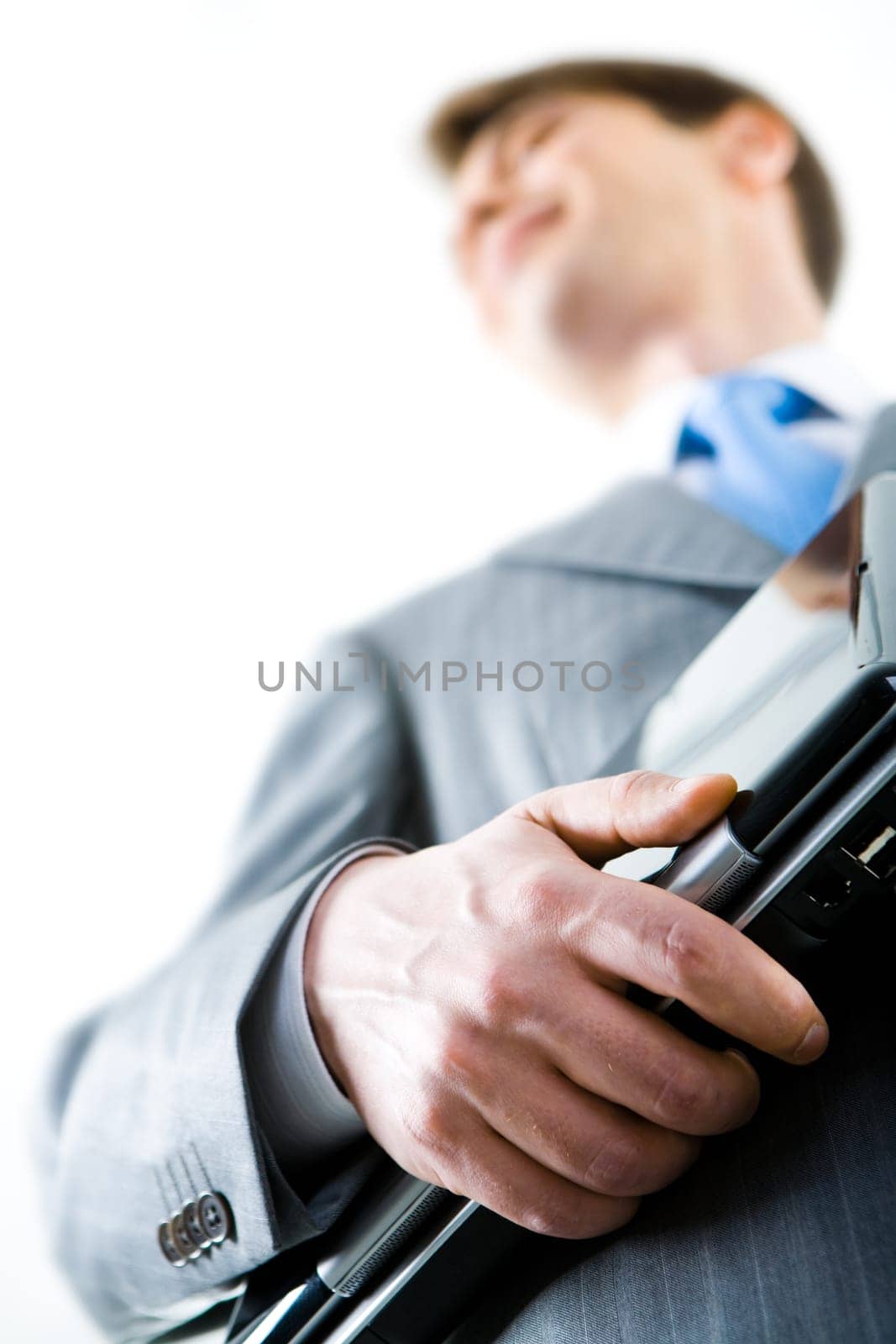 Photo of businessman in grey suit holding the laptop