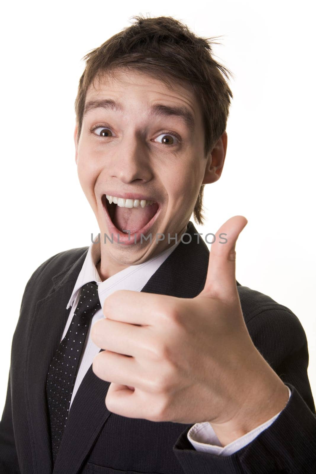 Portrait of amazed businessman with open mouth keeping his thumb up