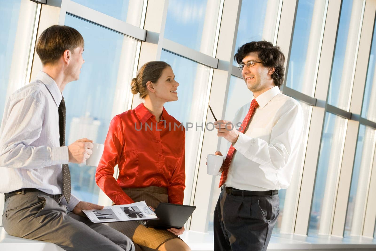 Portrait of businessman explaining new project to his colleagues