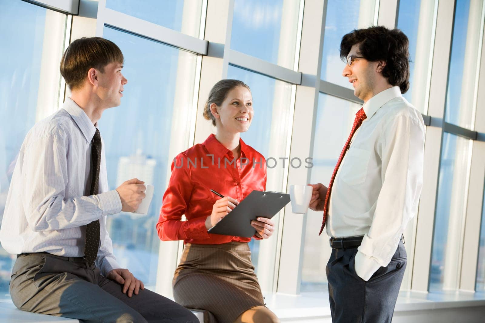 Portrait of three business people discussing new project at meeting
