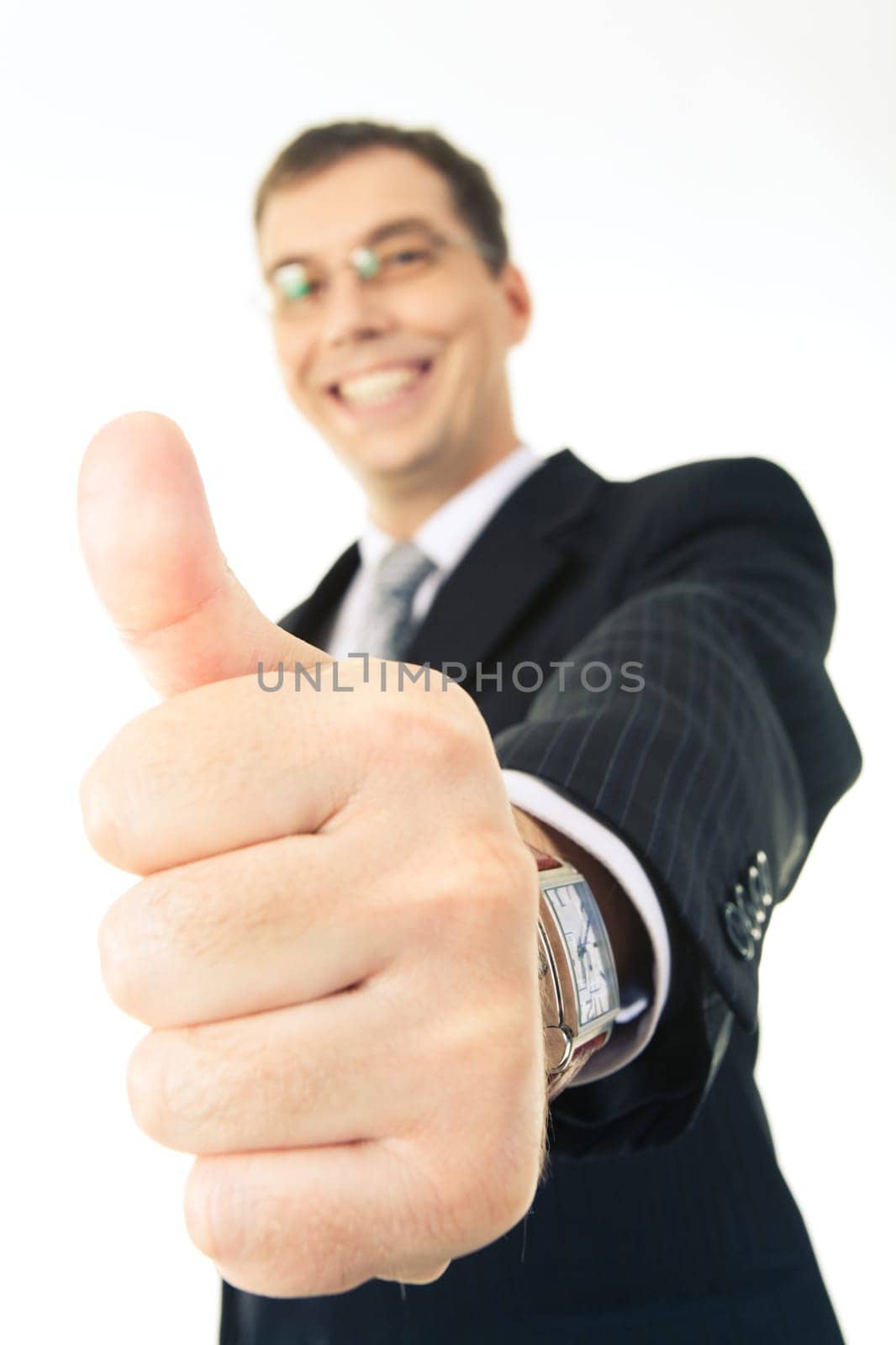 Close-up of thumb up on the background of happy businessman looking at camera