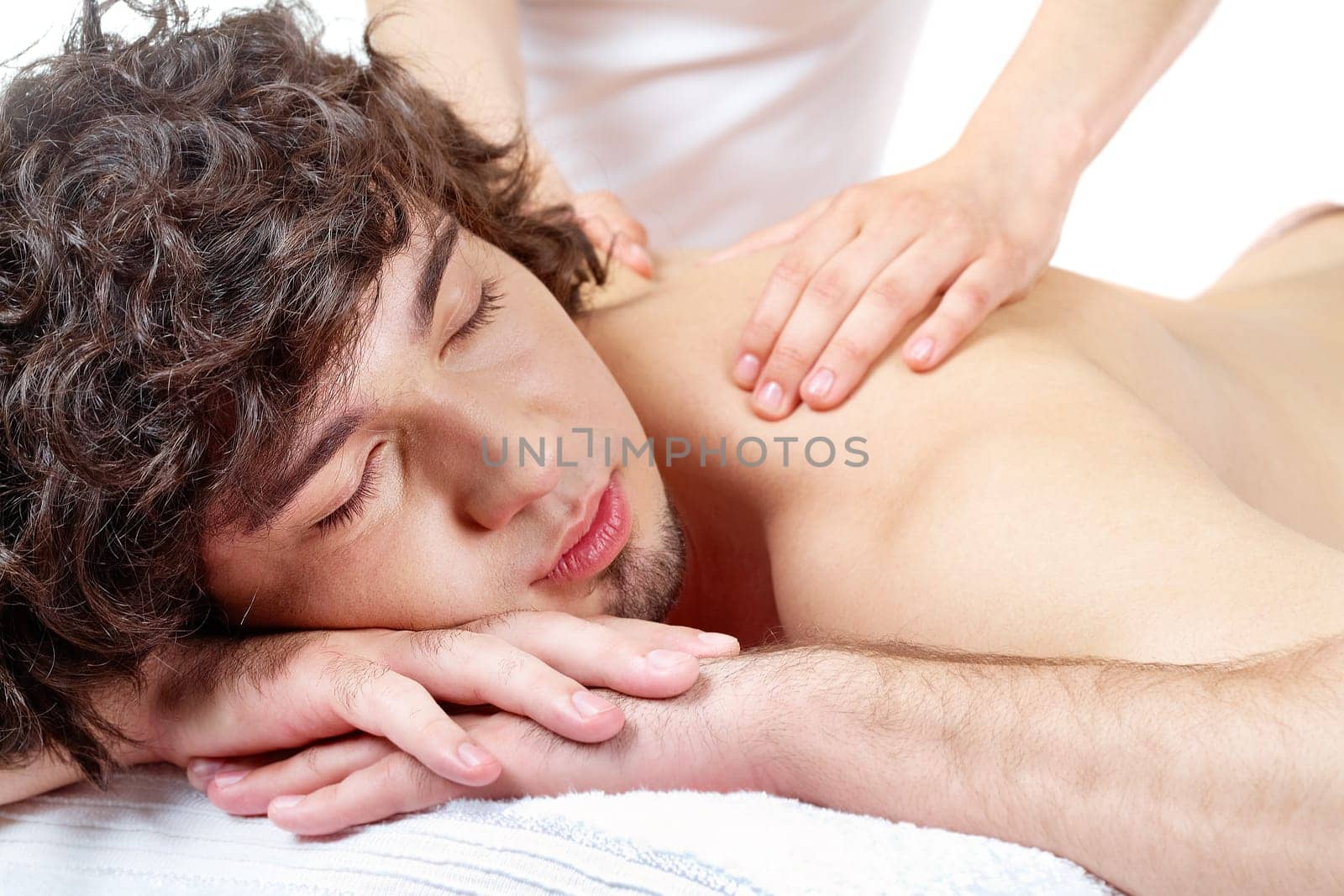 Portrait of calm guy enjoying the procedure of massage