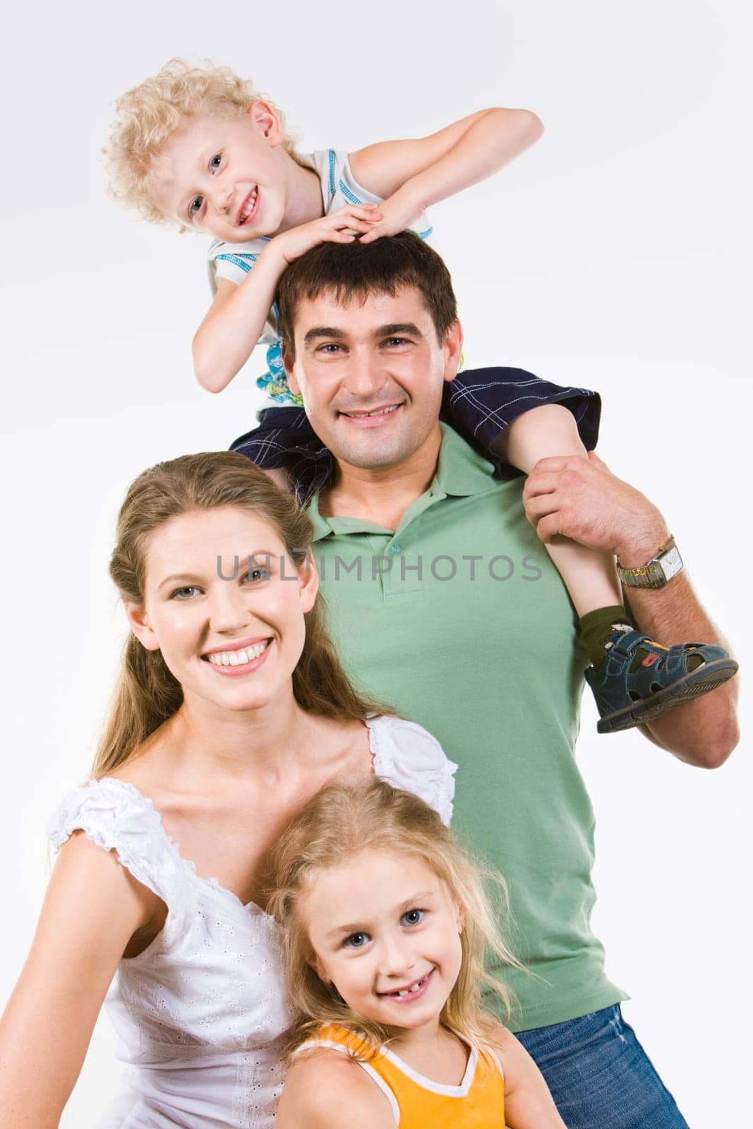 Portrait of four happy people looking at camera in the studio