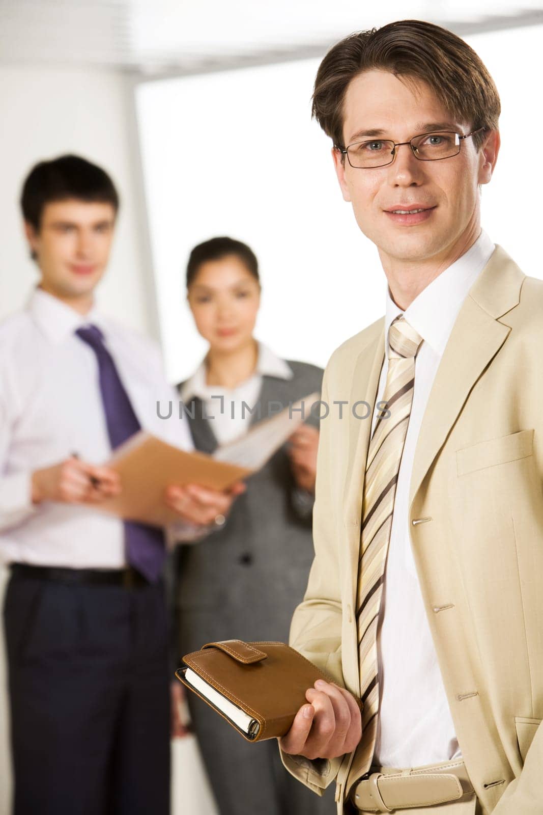Vertical image of contemporary man holding his organizer in the office