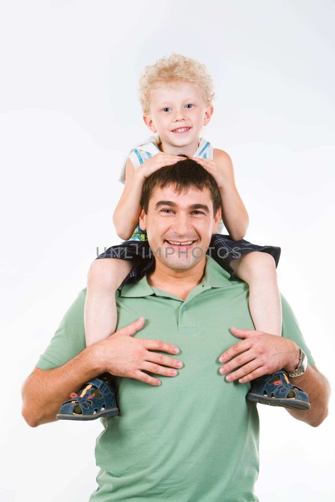 Portrait of man holding smiling son on the neck
