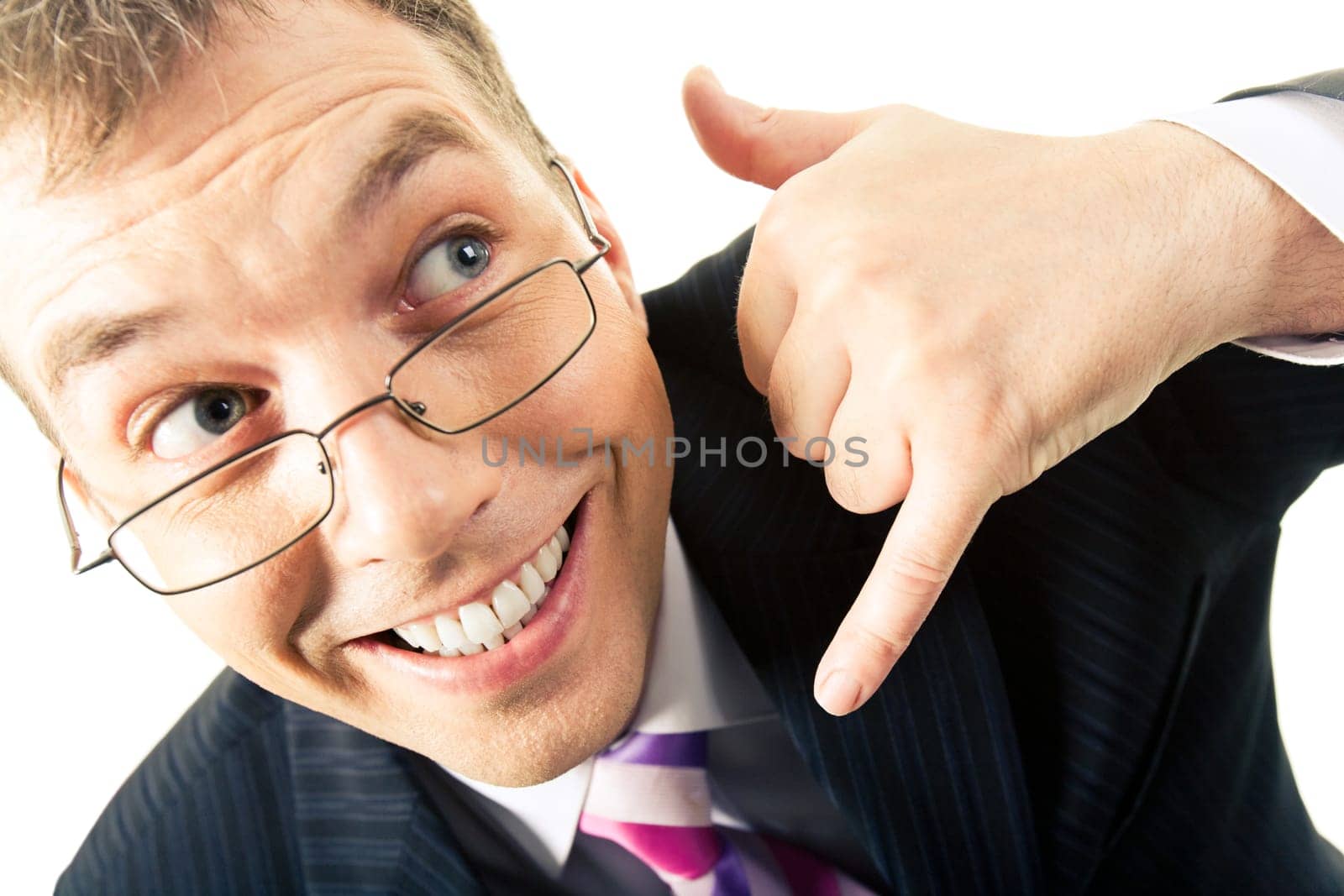 Close-up of businessmans happy face holding his hand with imaginary cell phone by his ear