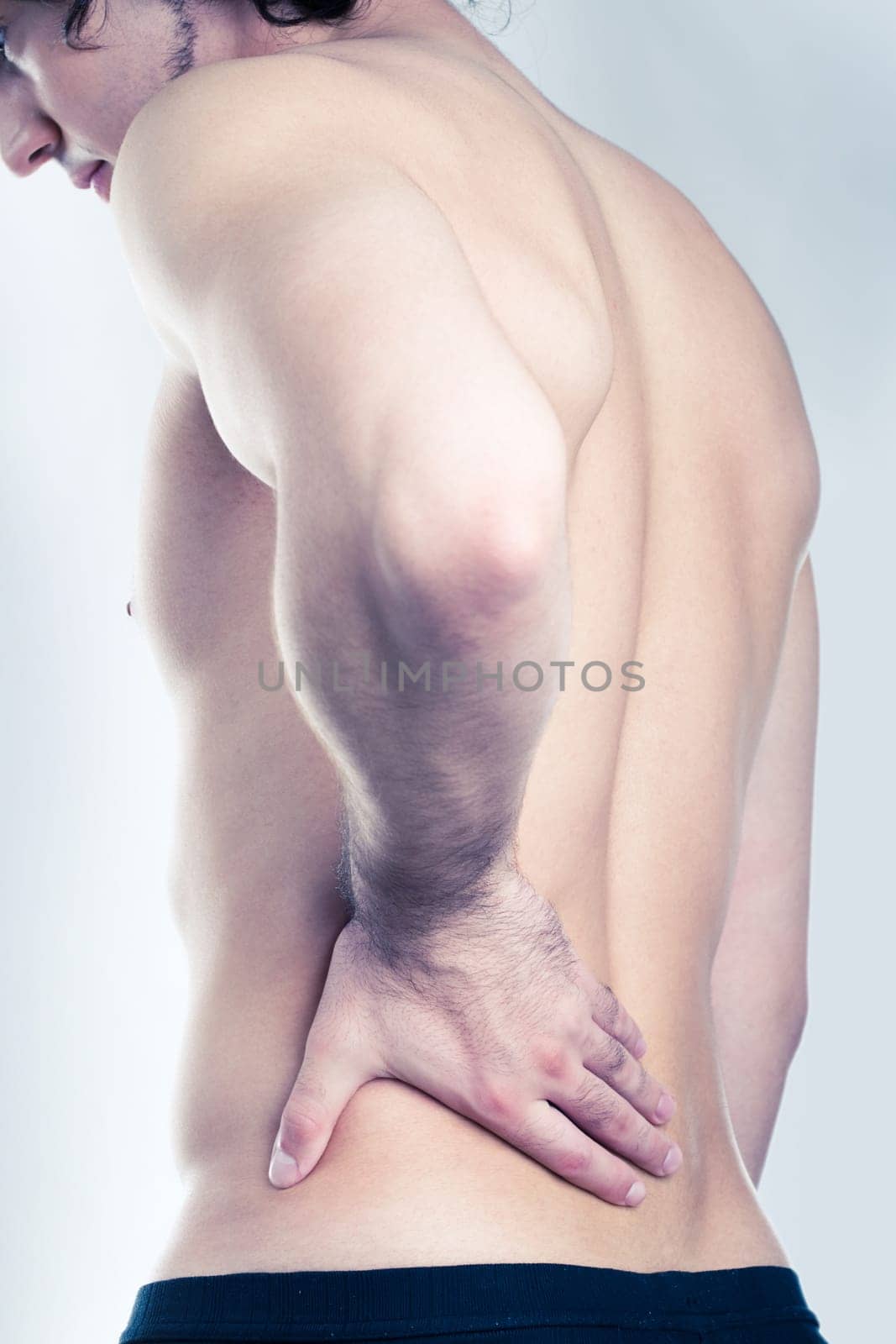 Photo of man with back pain isolated on a blue background