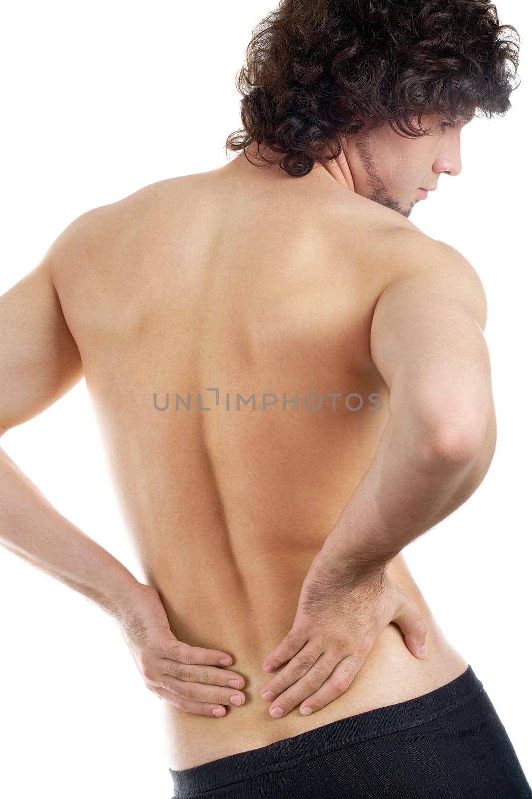 Back view of young man touching aching back