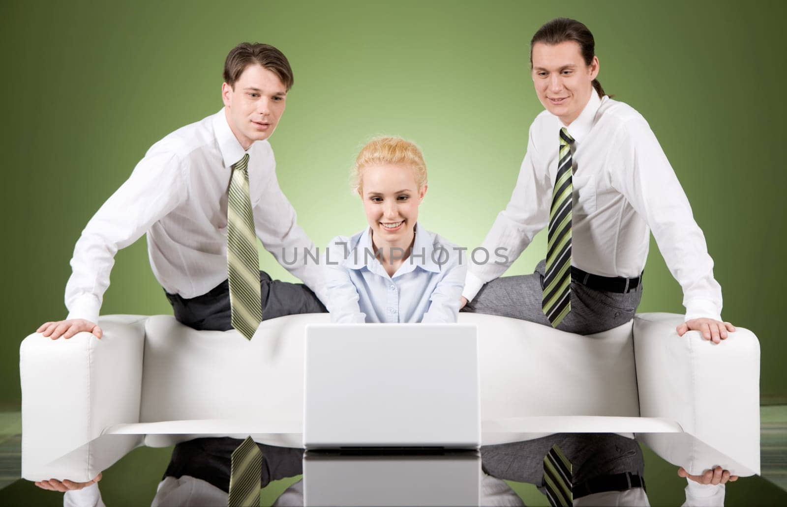 Photo of attractive woman typing on laptop with two men sitting behind her
