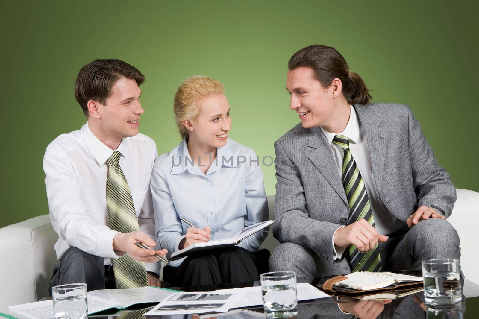 Photo of confident business people communicating at meeting