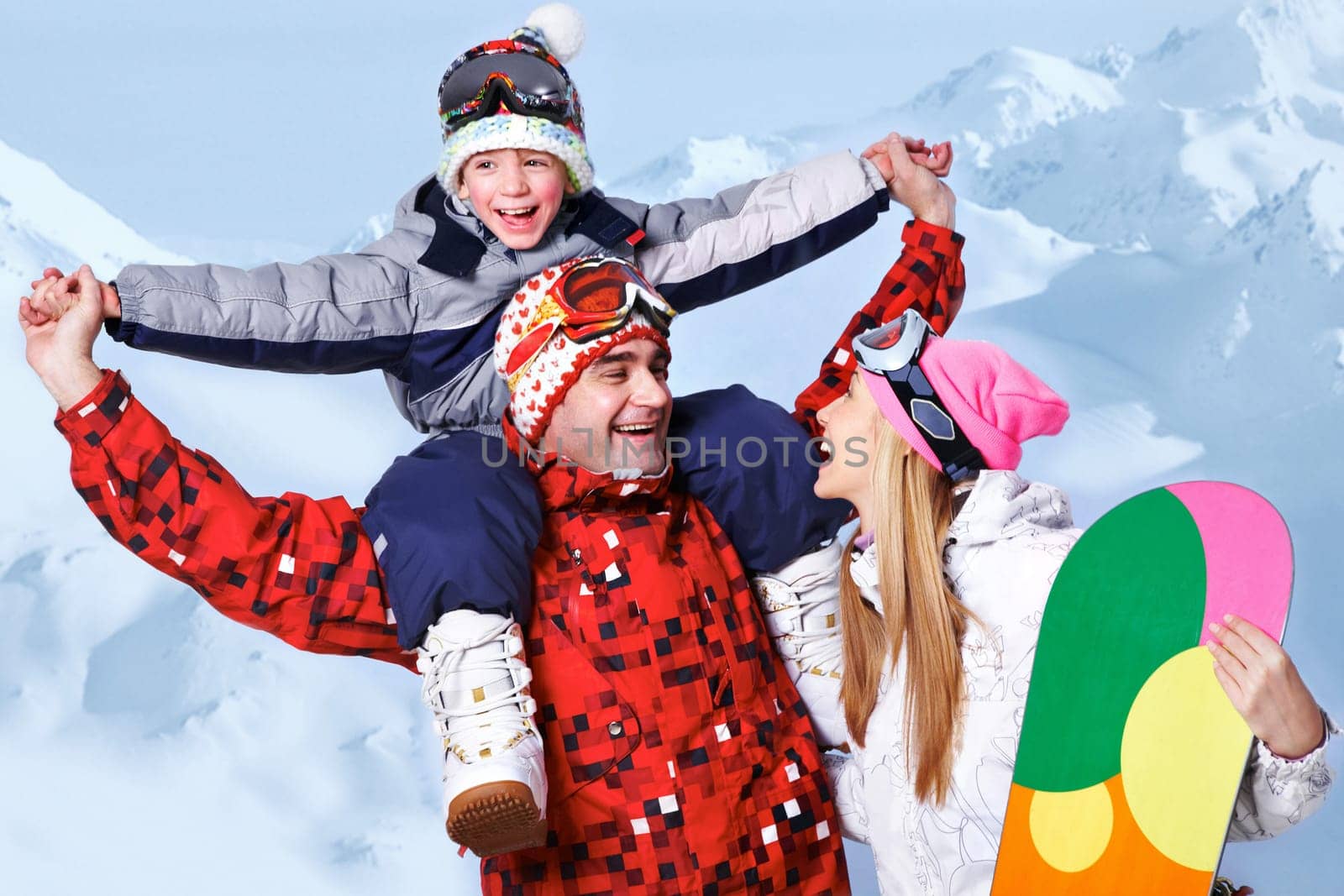 Portrait of happy family with snowboards having fun on winter resort