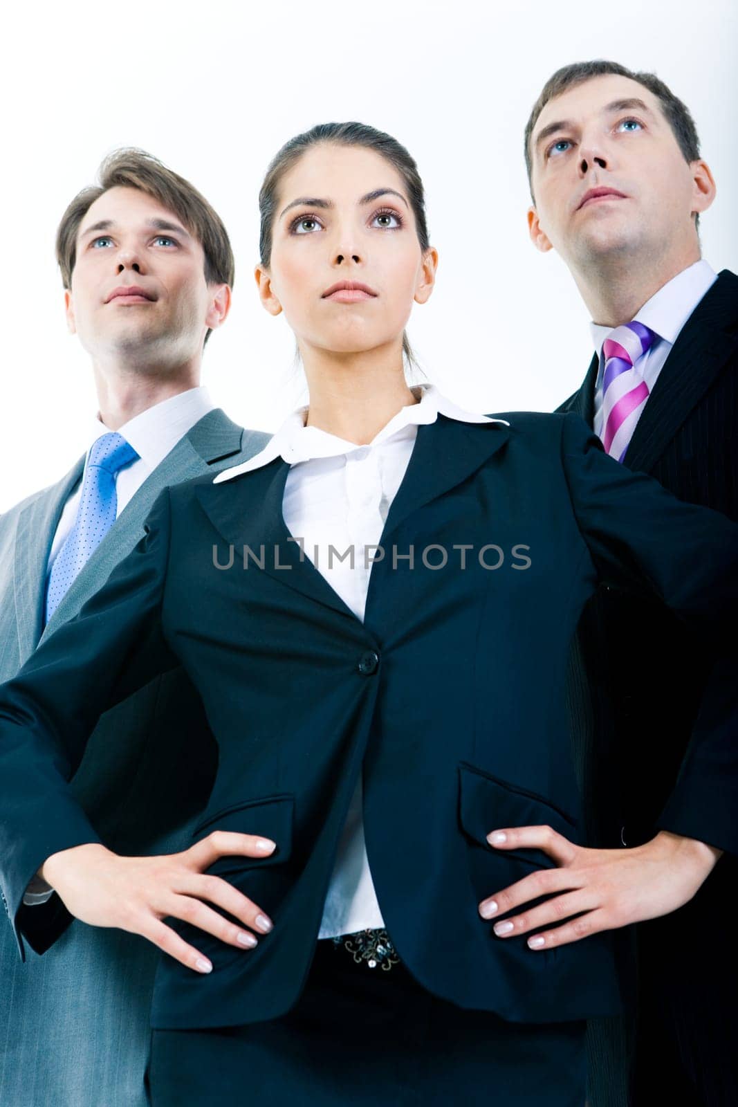 Portrait of three confident business partners looking forward with serious faces