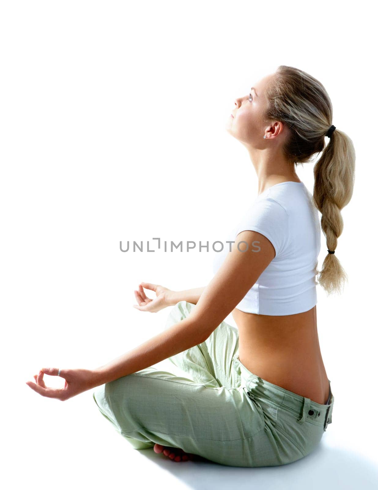 Attractive woman meditating in pose of lotus and looking at light