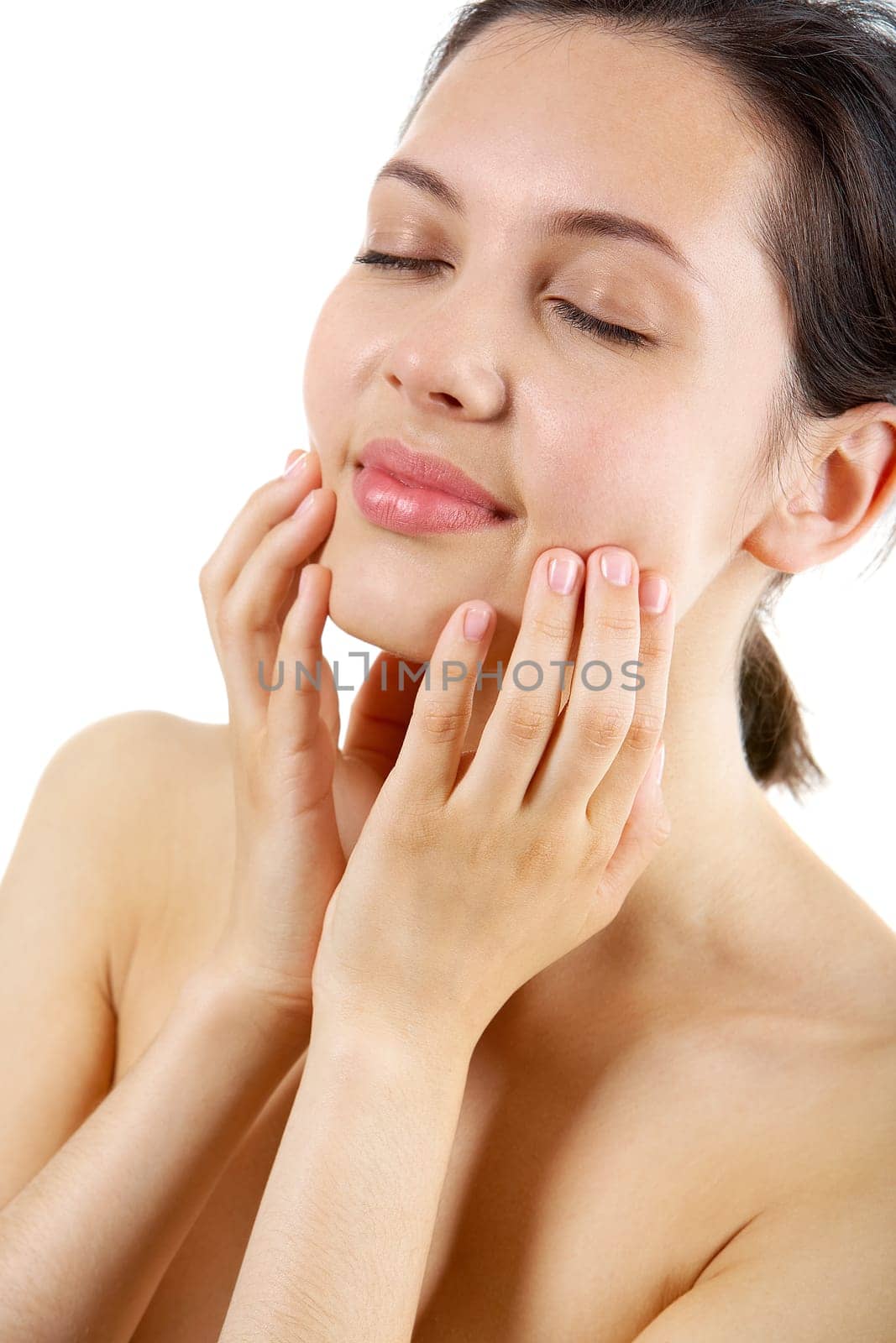 Portrait of calm female with her hands on face taking pleasure