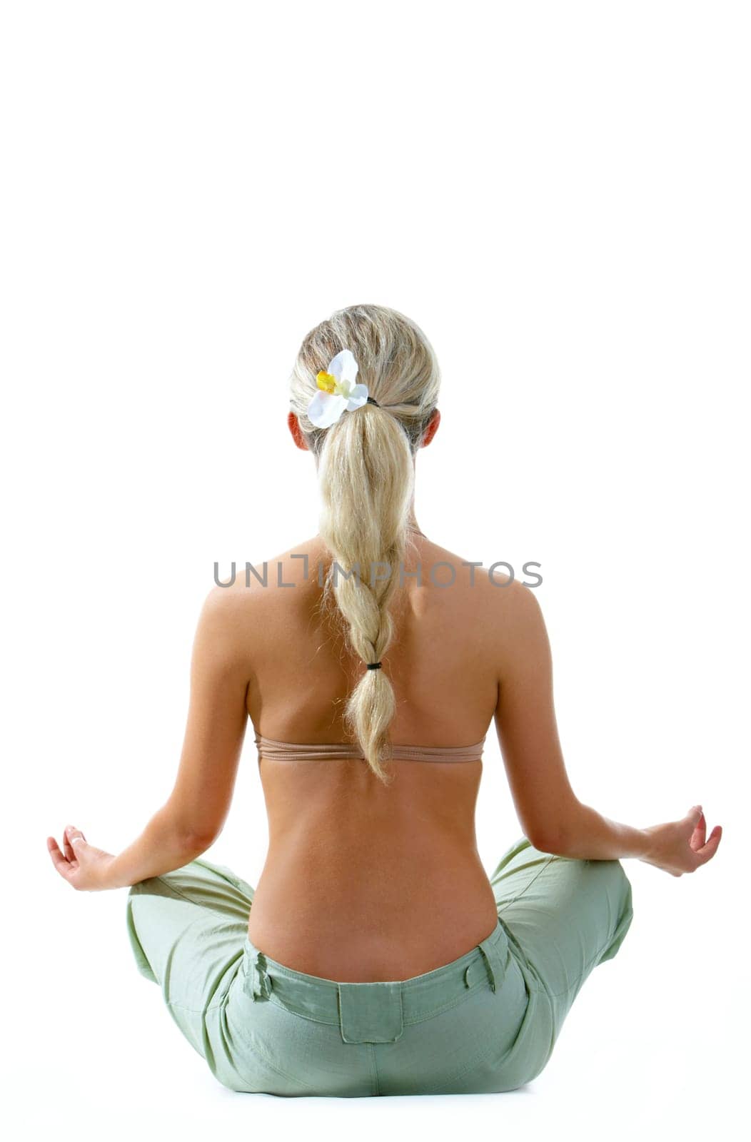 Rear view of meditating woman sitting over white background