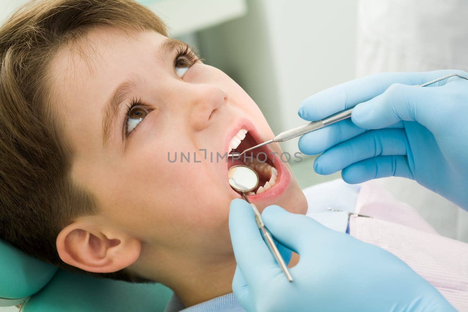 Close-up of little boy opening his mouth during dental checkup