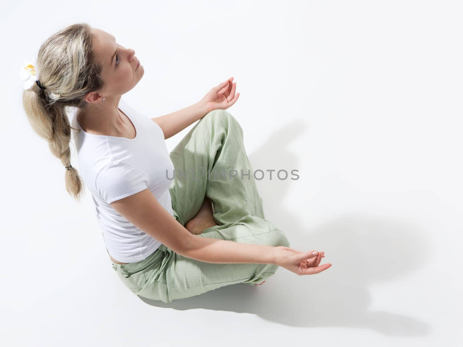 Above view of fit woman sitting and meditating