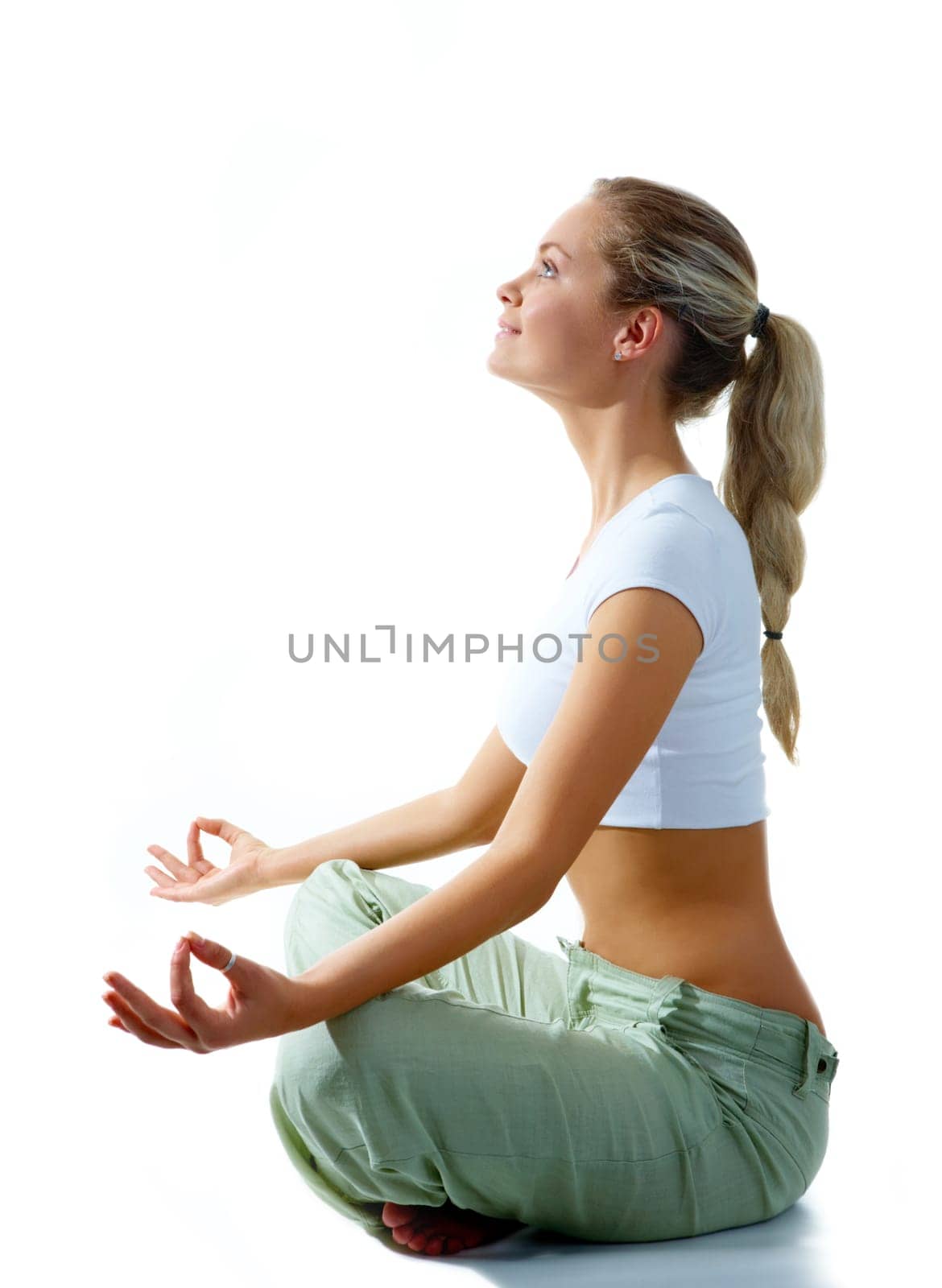 Profile of woman meditating in pose of lotus in isolation