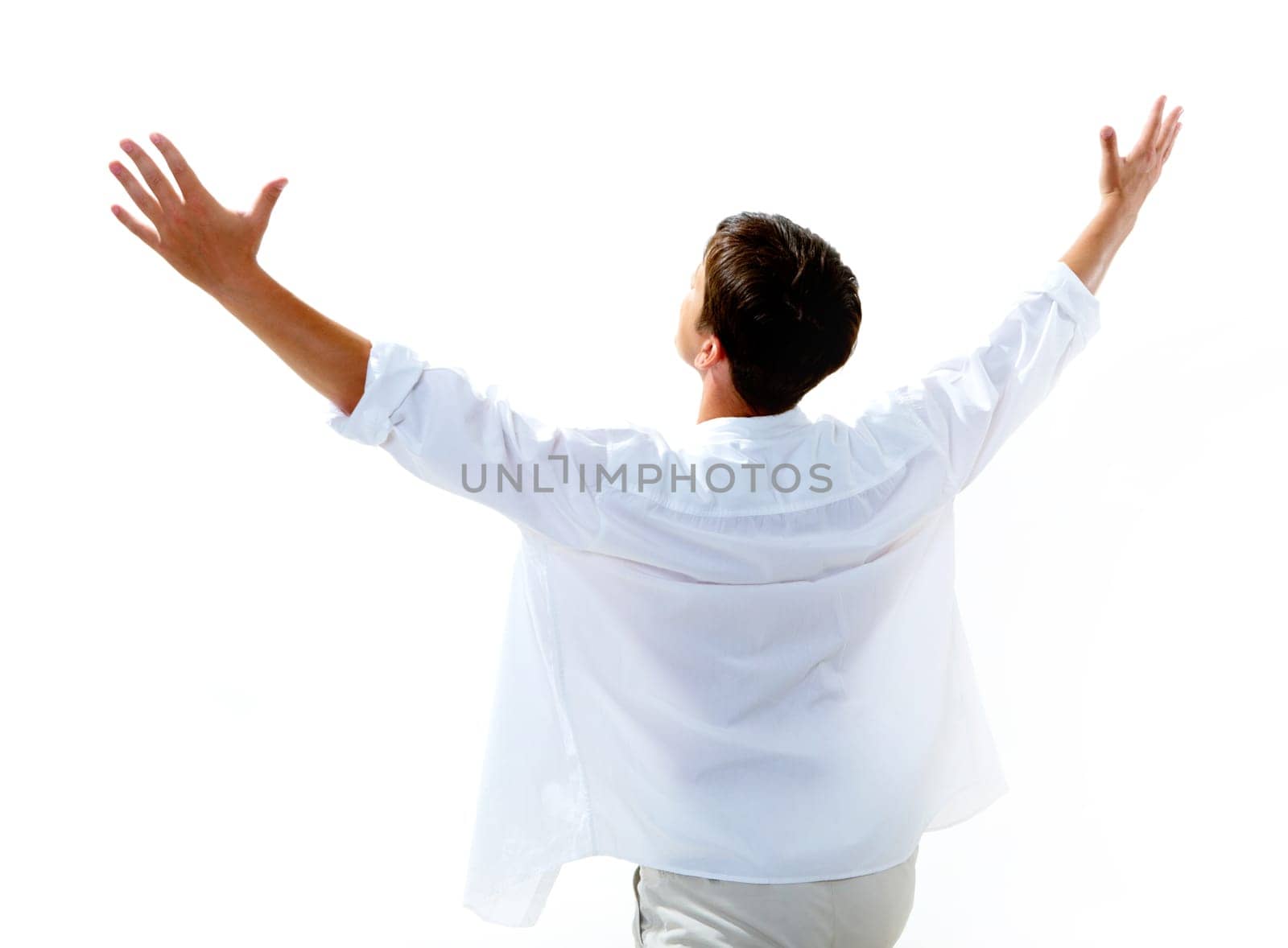 Back view of happy young man raising his arms enjoying life