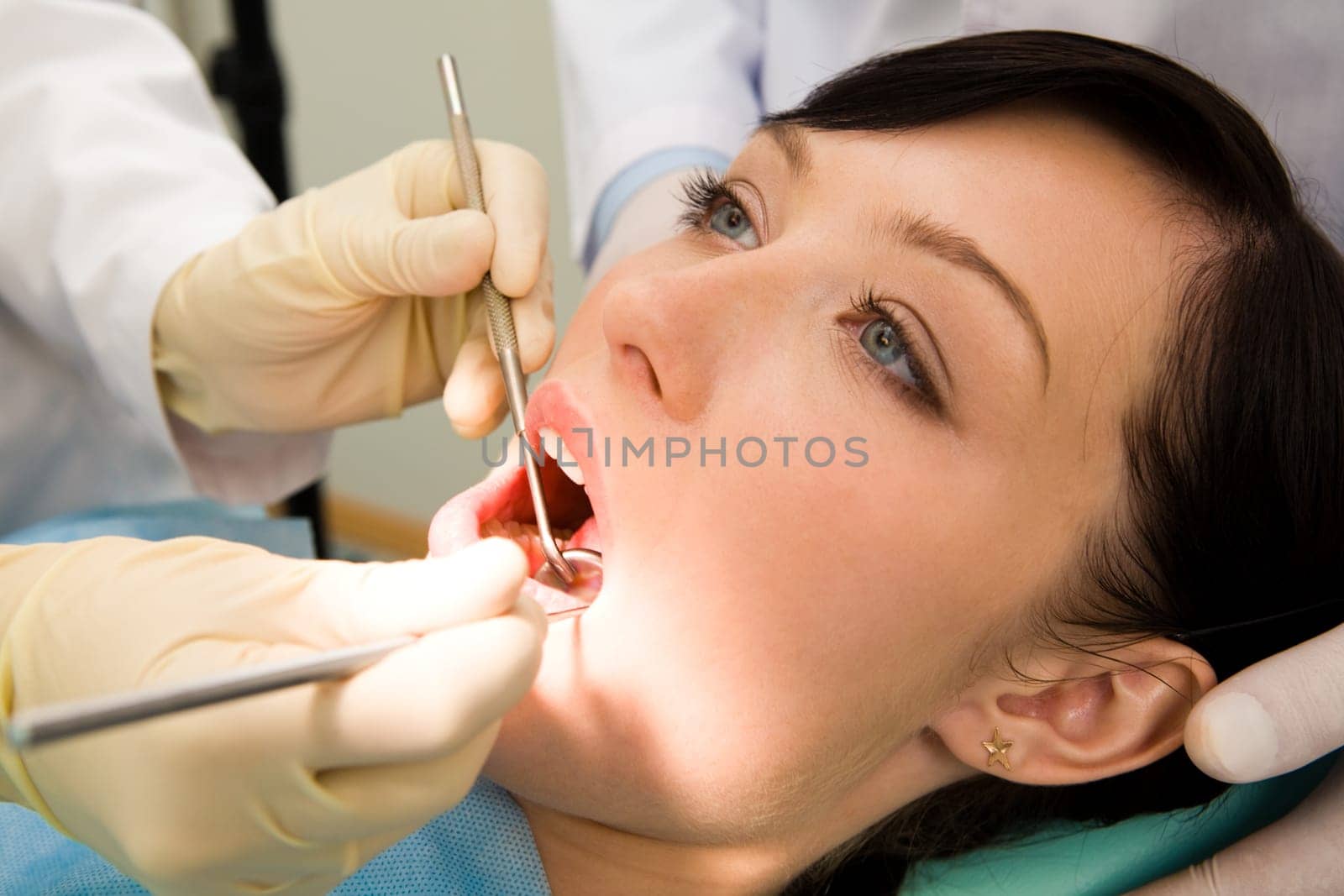 Close-up of female patient having her teeth examined by specialist