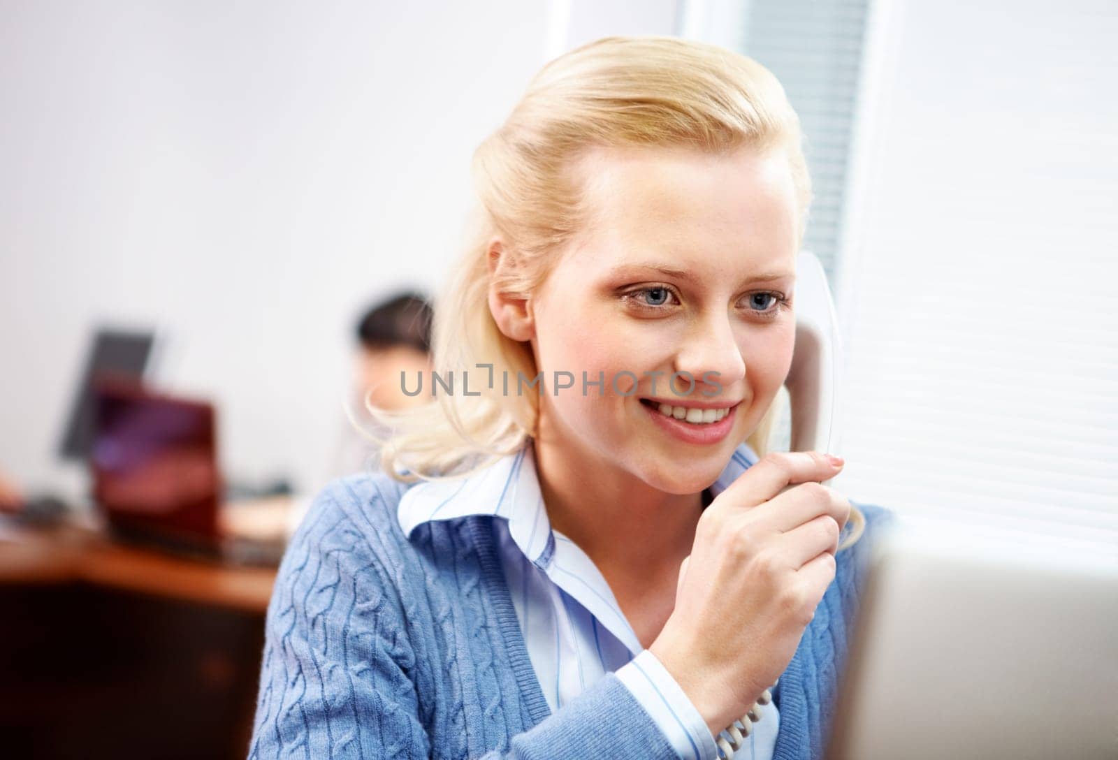A young woman secretary answering a call